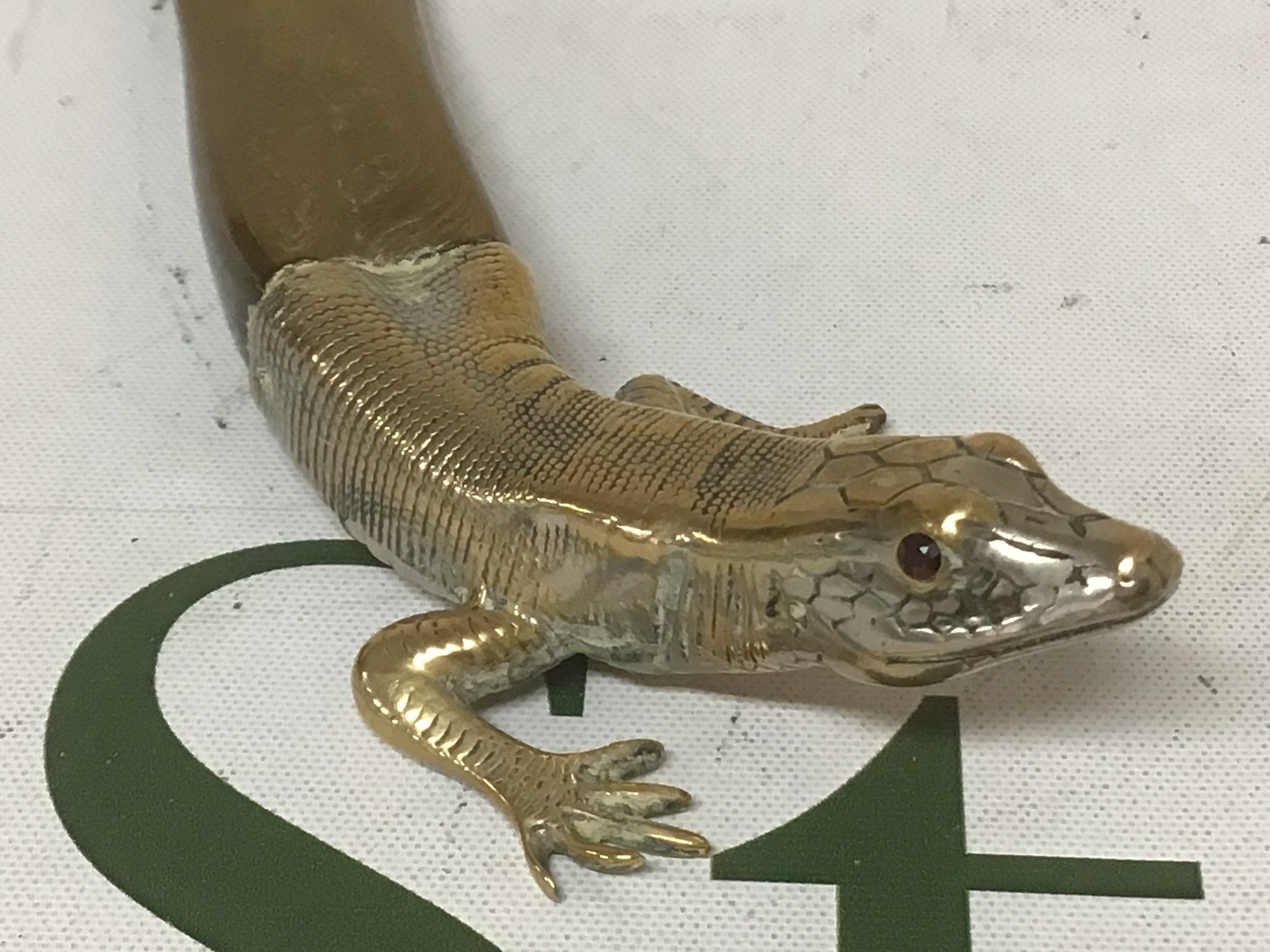 An Antique paper Knife with a shaped horn blade the end in the form of a lizard made in brass.- NO RESERVE