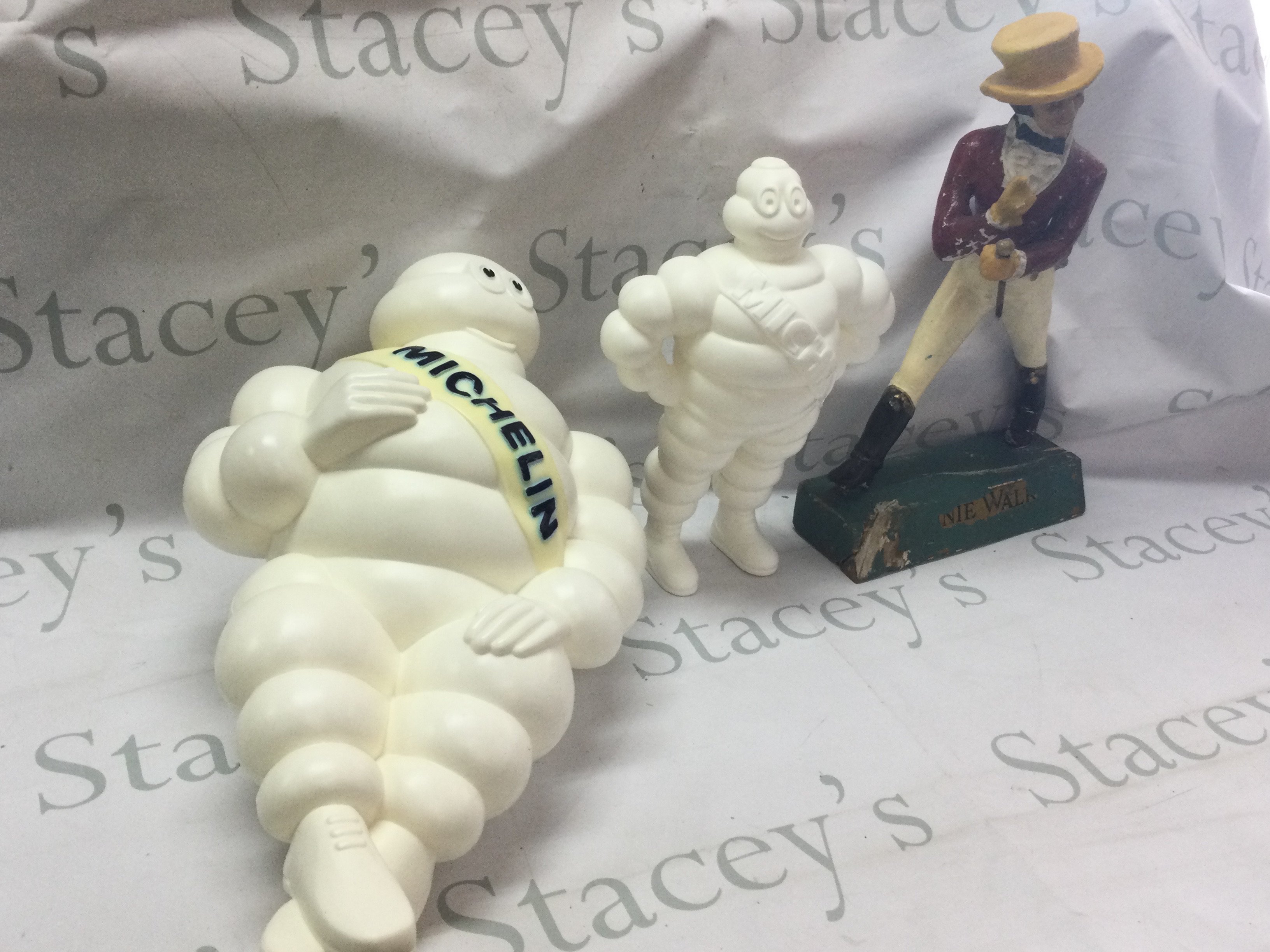 Three vintage advertising figures including Johnnie Walker (39cm tall) and Michelin Men (31cm & 47cm tall) both made in France, one with a mount.