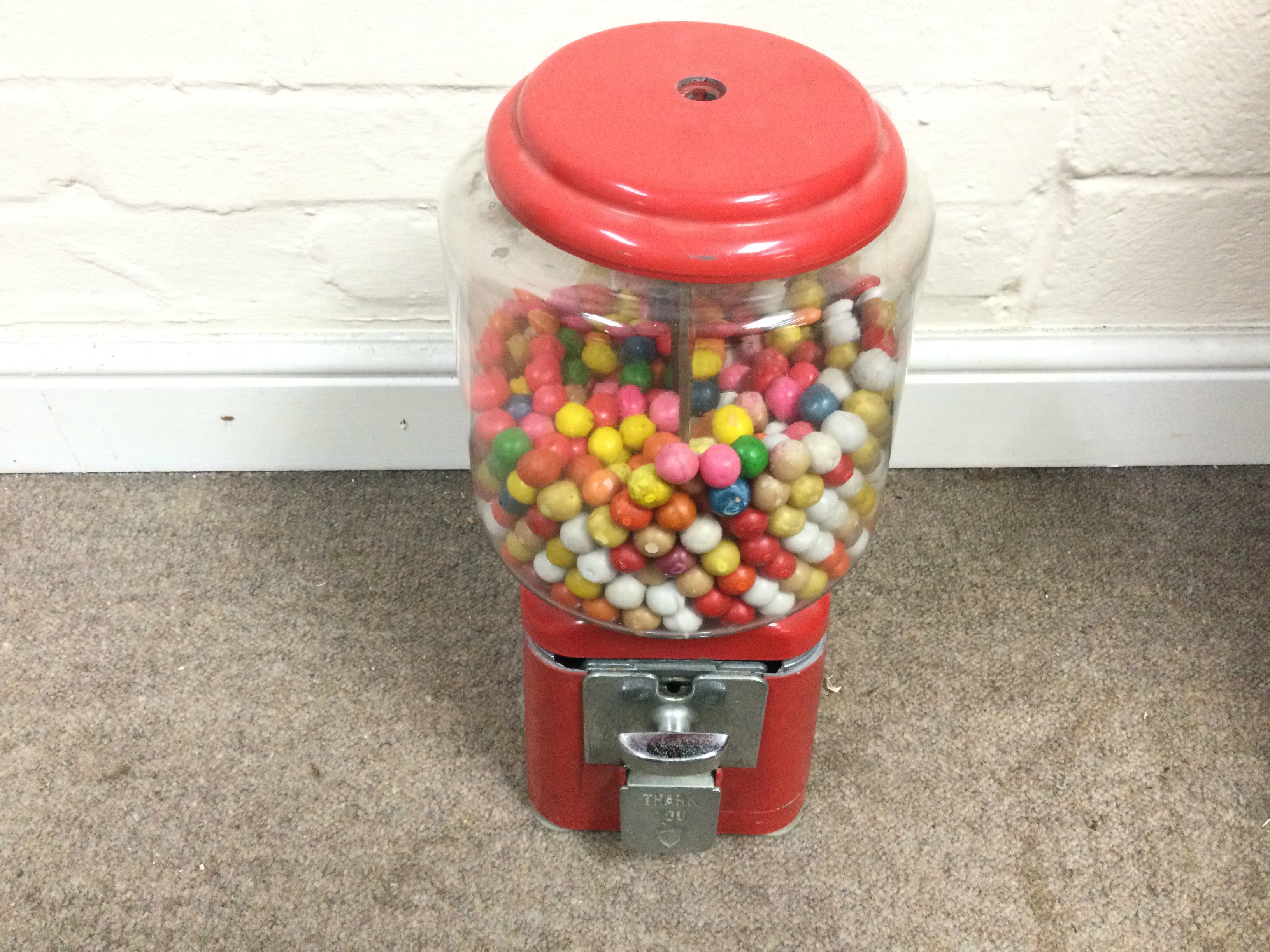 A vintage American coin op bubble gum machine. Approximately 43 cm by 16cm,