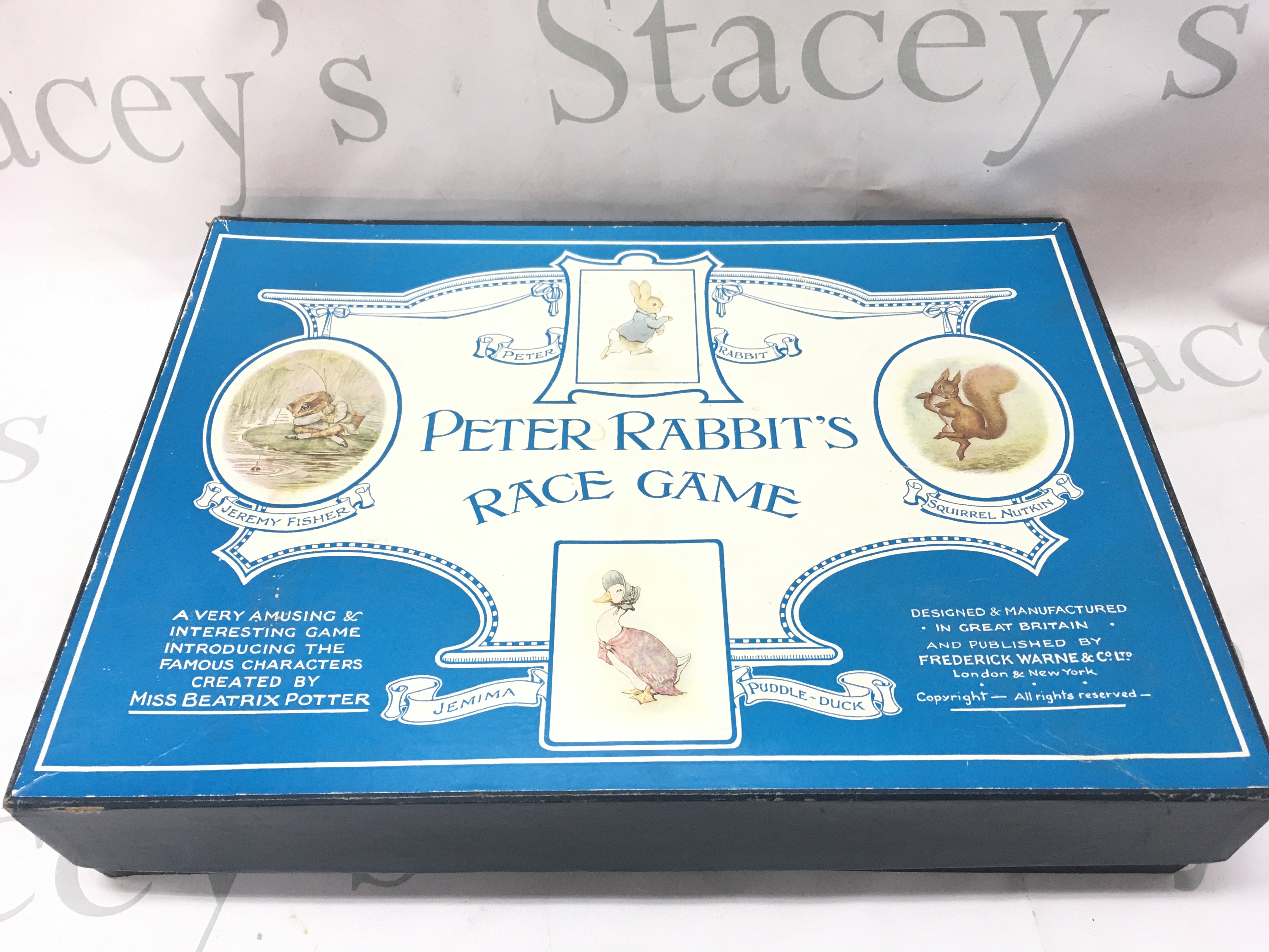 A boxed vintage Peter rabbits race game , postage category C