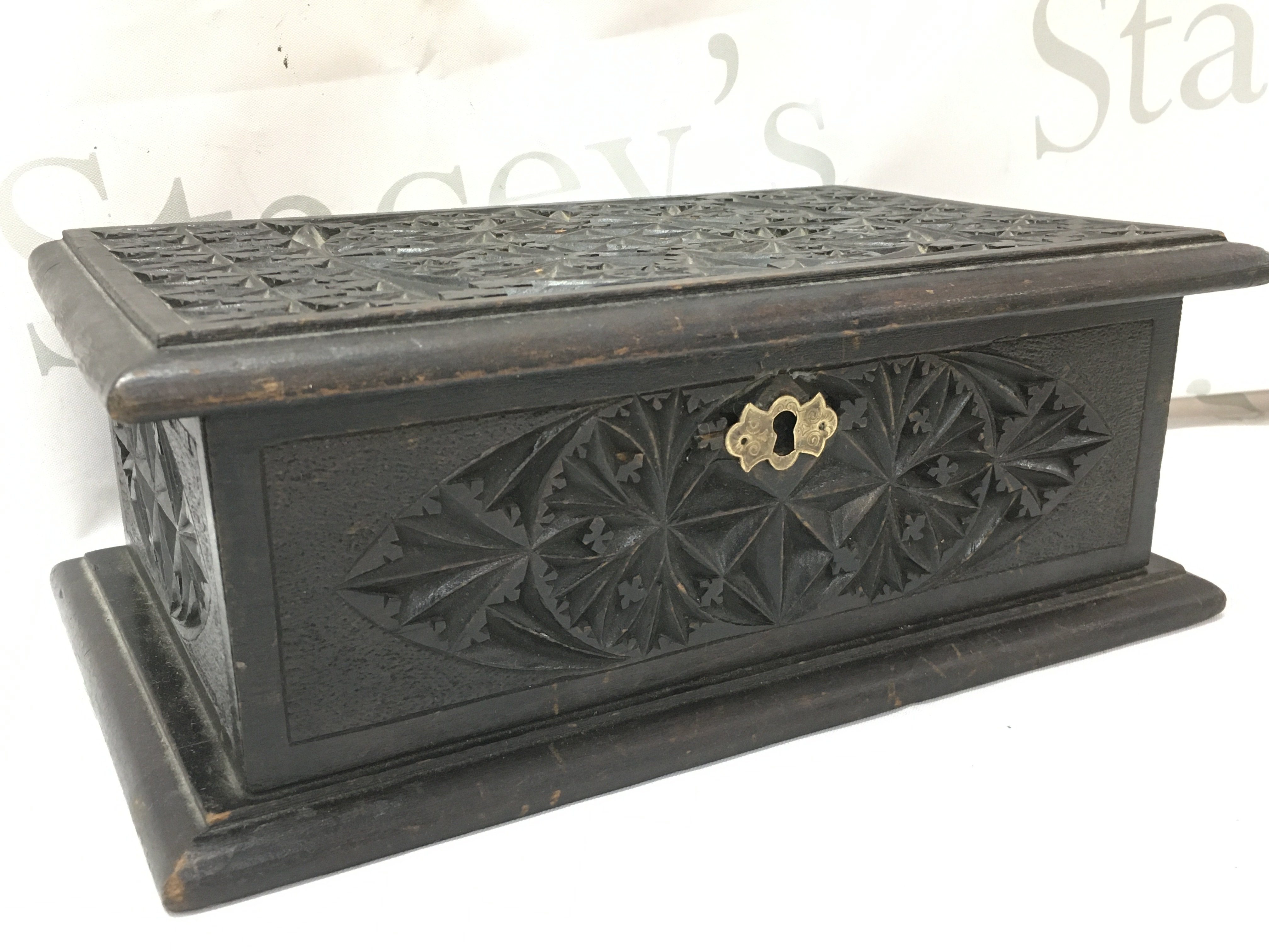 A Victorian carved black jewellery box , lined. Dimensions 18x28x11cm