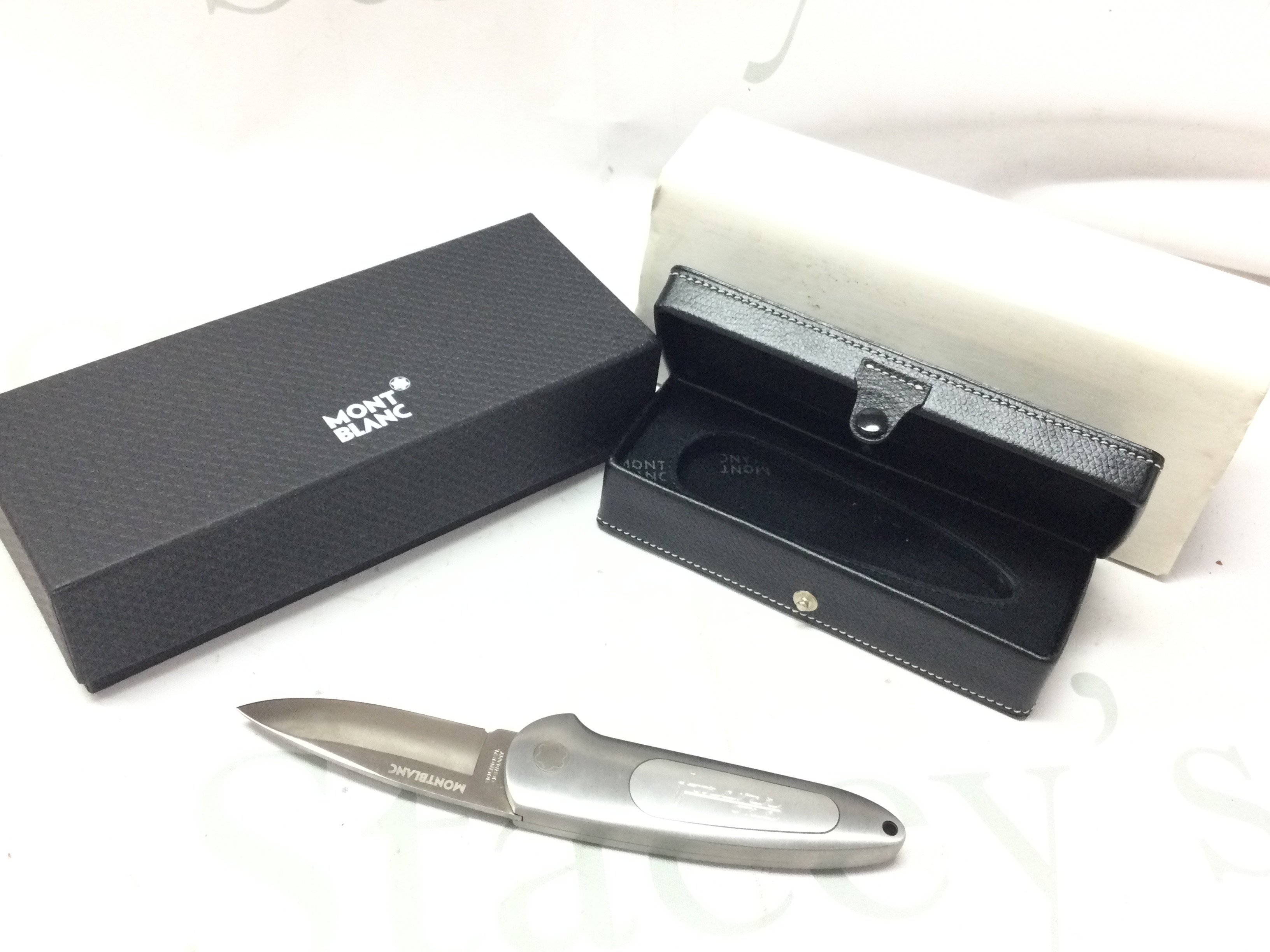 A boxed Mont Blonc stainless steel pocket knife with forever one super yacht engraving. This lot cannot be posted