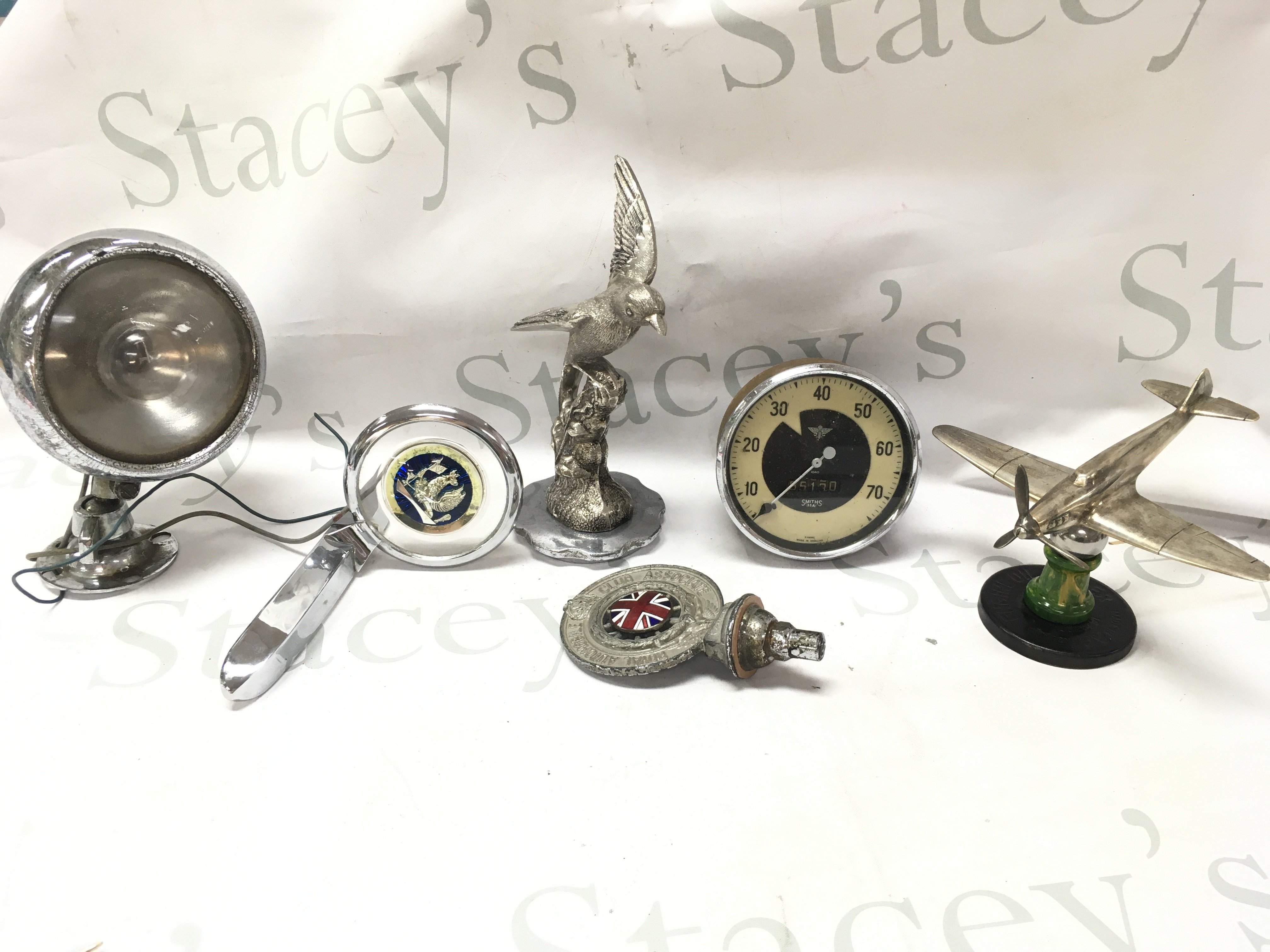 Vintage motoring items including a silver tone swallow mascot figurine , vintage chrome spotlight, Royal Automobile badge, Smiths speedometer, Hurricane aircraft mascot. This lot cannot be posted