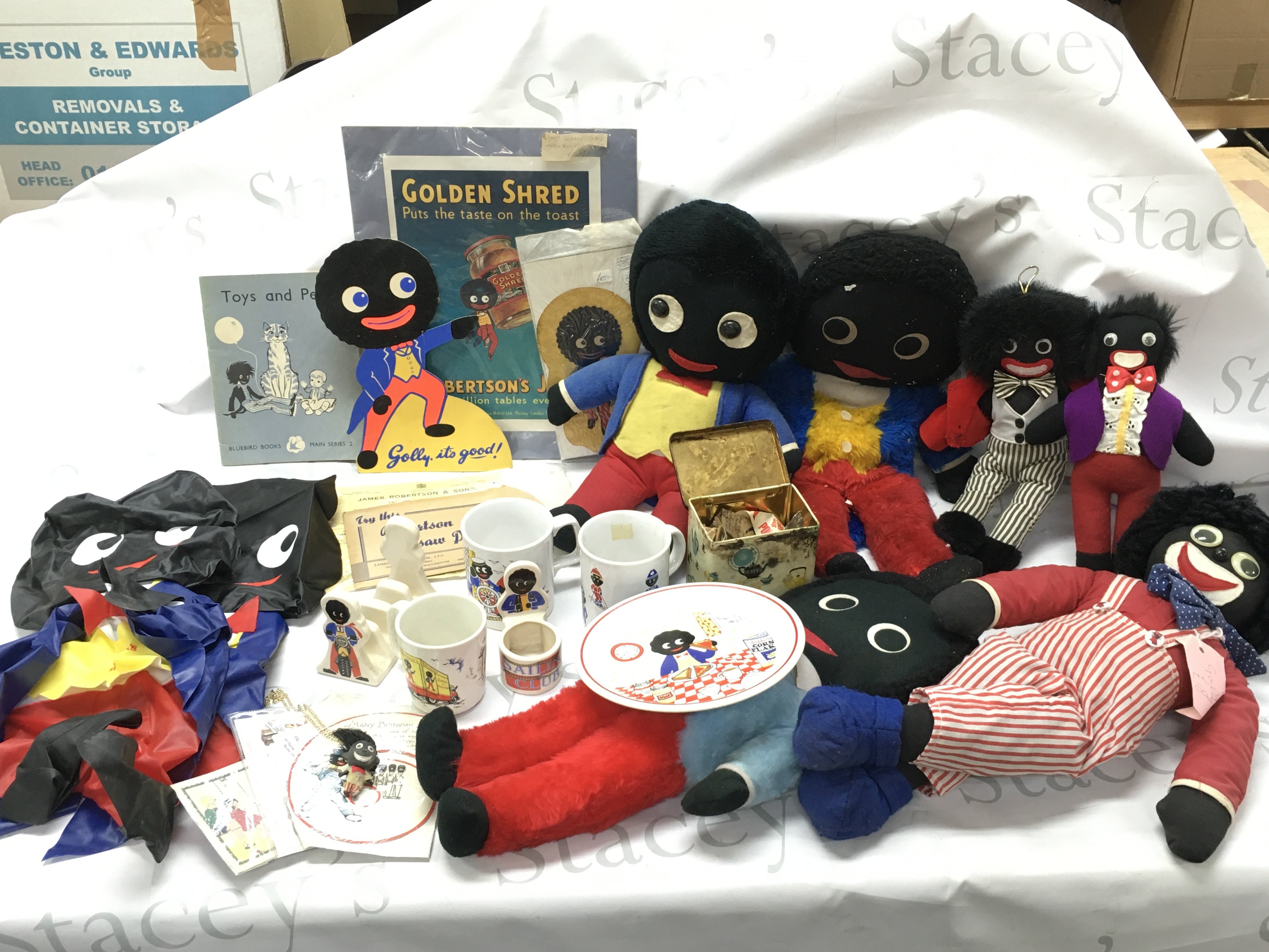 A collection of vintage golly items including soft toys, Robertsons mugs, plate, sailing club egg cup , inflatable blow up figures, shop window adverts and other advertising items. This lot cannot be posted