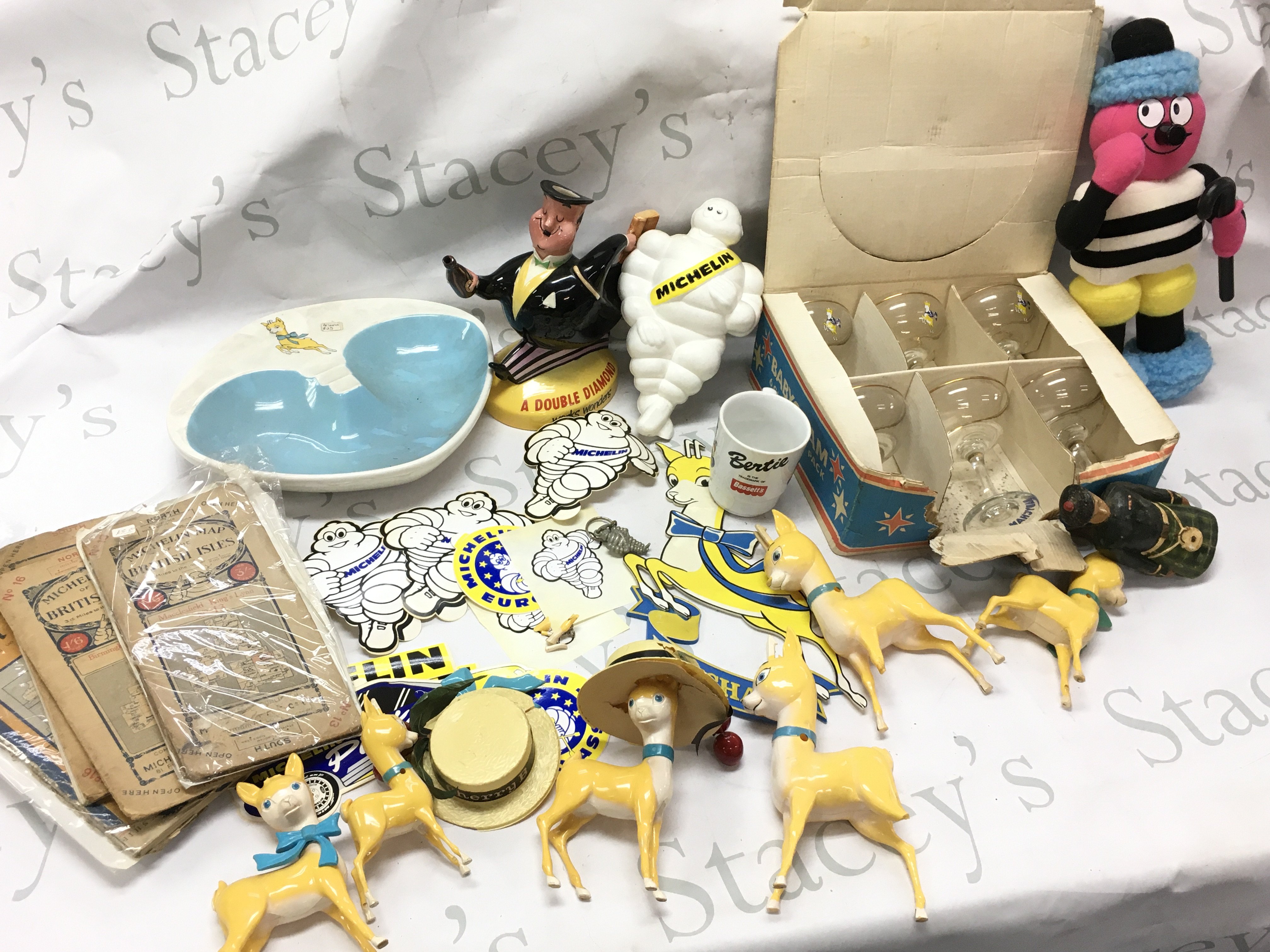 A collection of advertising items including a Bassetts man soft toy figure, Beswick Double Diamond porcelain figure, Michelin man figure, collection of Michelin stickers , Baby Cham items ,Michelin maps. This lot cannot be posted
