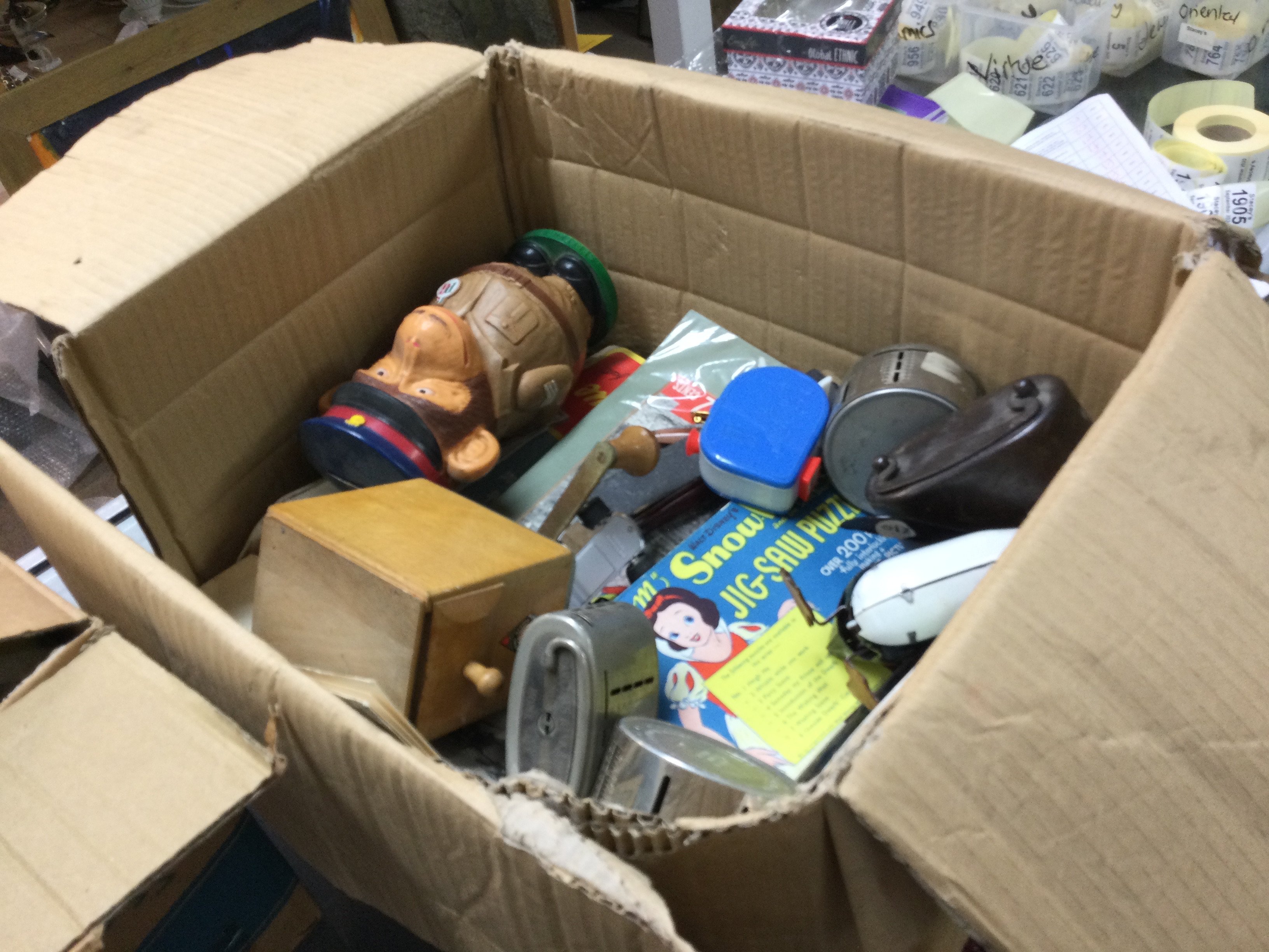 A box of mixed vintage items including a PG Tips monkey money box, Snow White jig saw puzzle, solar system toy etc. this lot cannot be posted