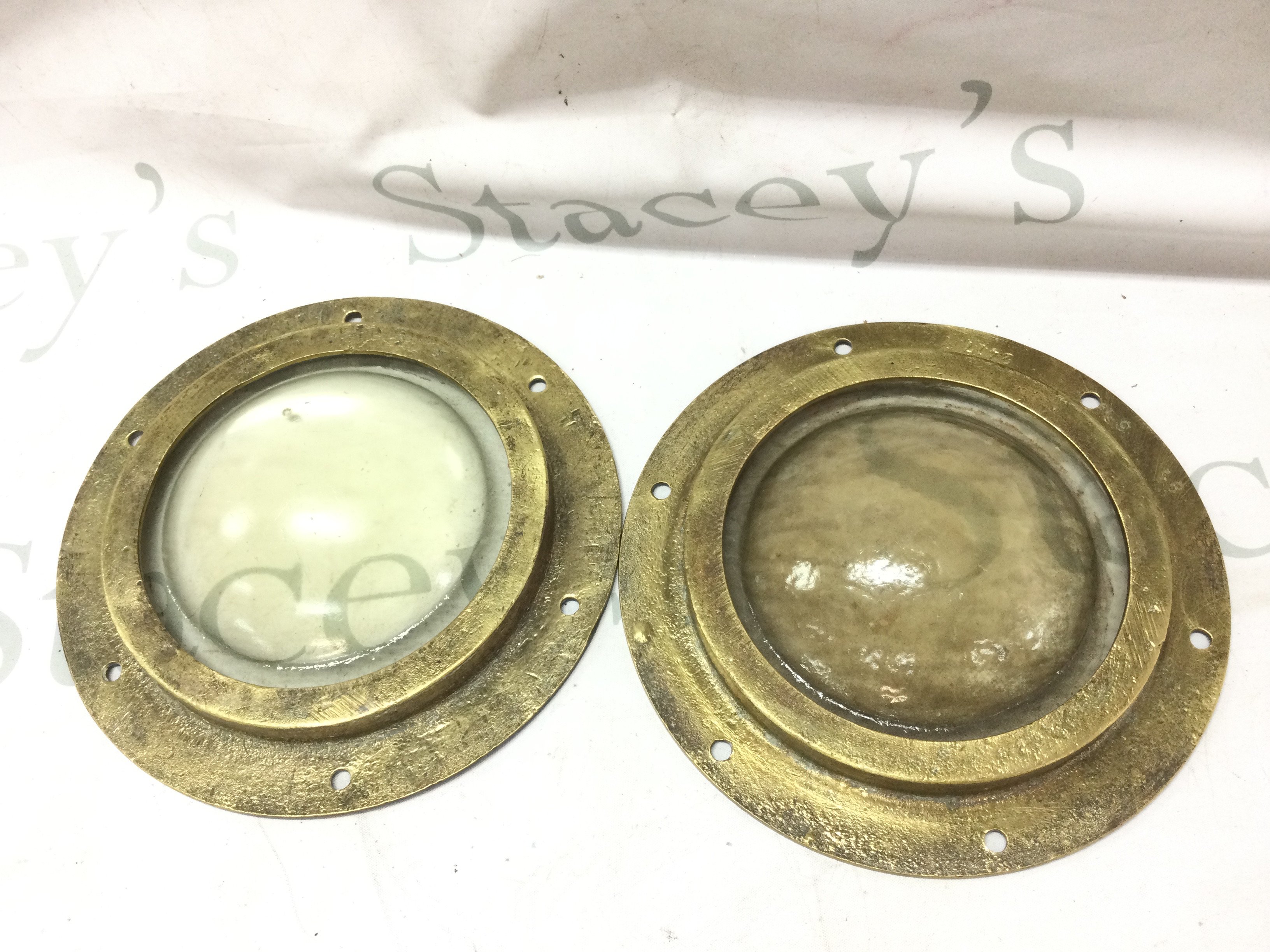 Two vintage brass portholes , thick glass. 22cm wide. This lot cannot be posted