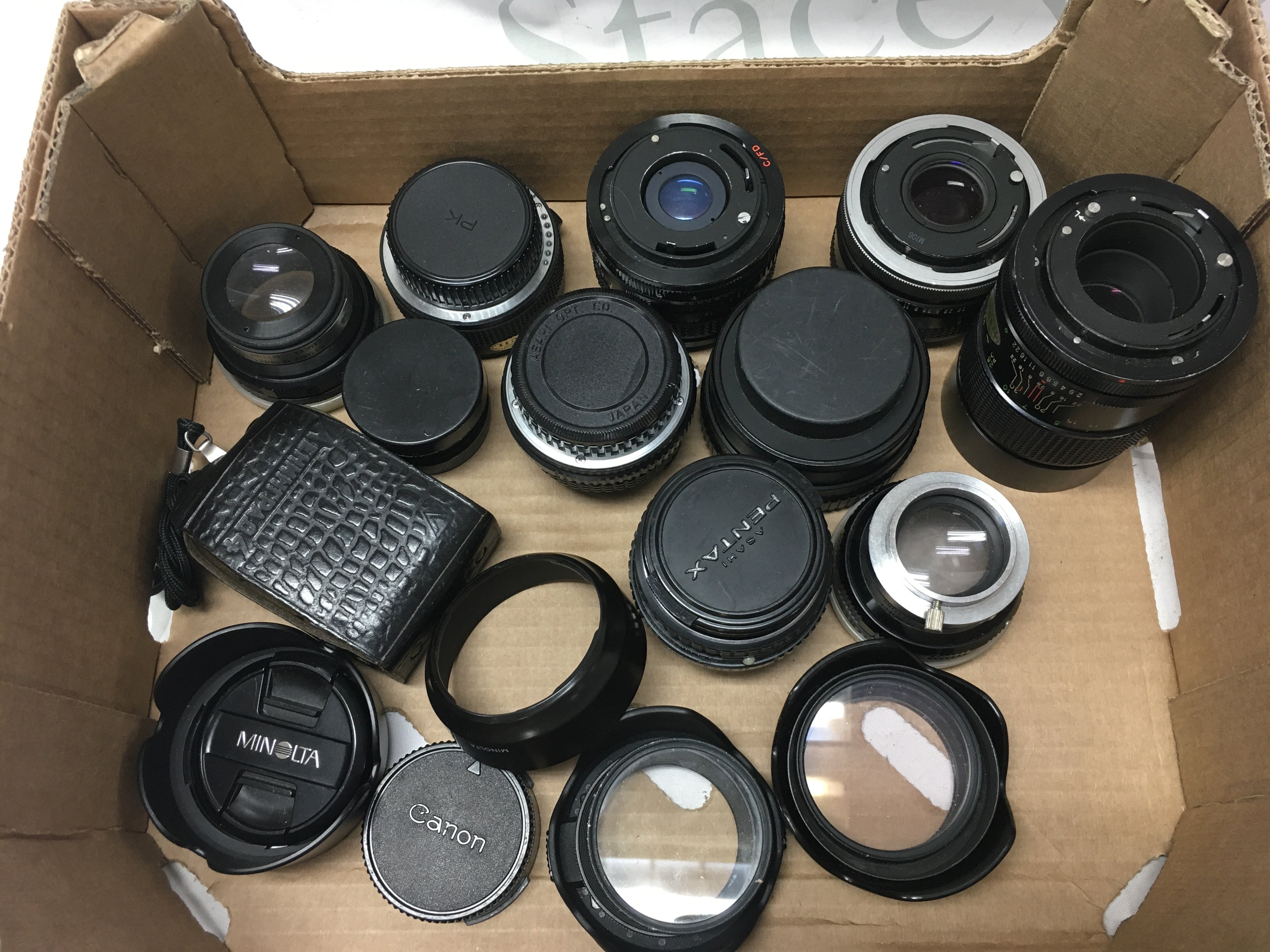Box of camera lenses including Vivitar, Pentax, , filters, lens cups, Leningrad 4 exposure light meter . Postage category B