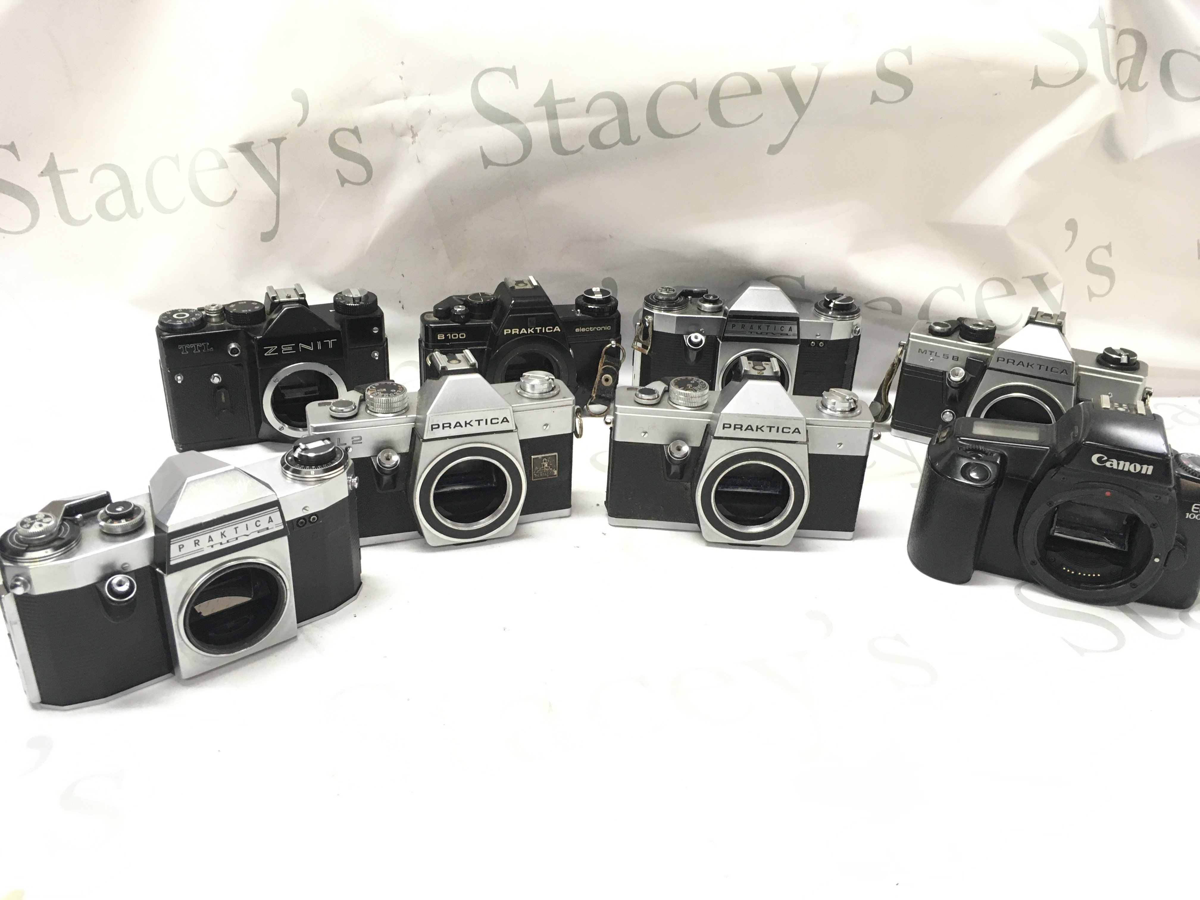 8 SLR cameras including Praktica, canon etc . Postage category C
