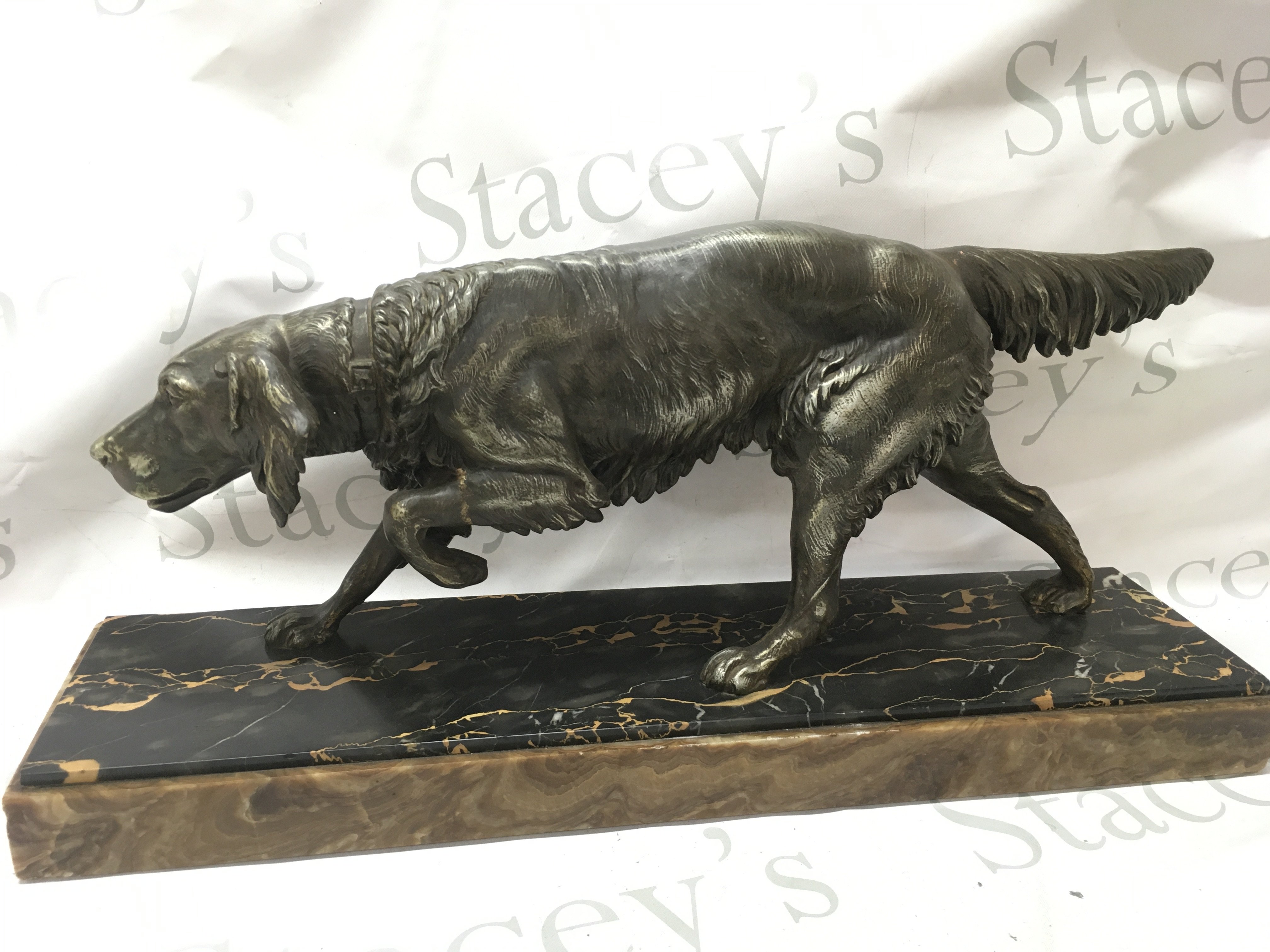 Art Deco spelter figure of a gun dog on a marble base 27.5cm tall 60cm wide.