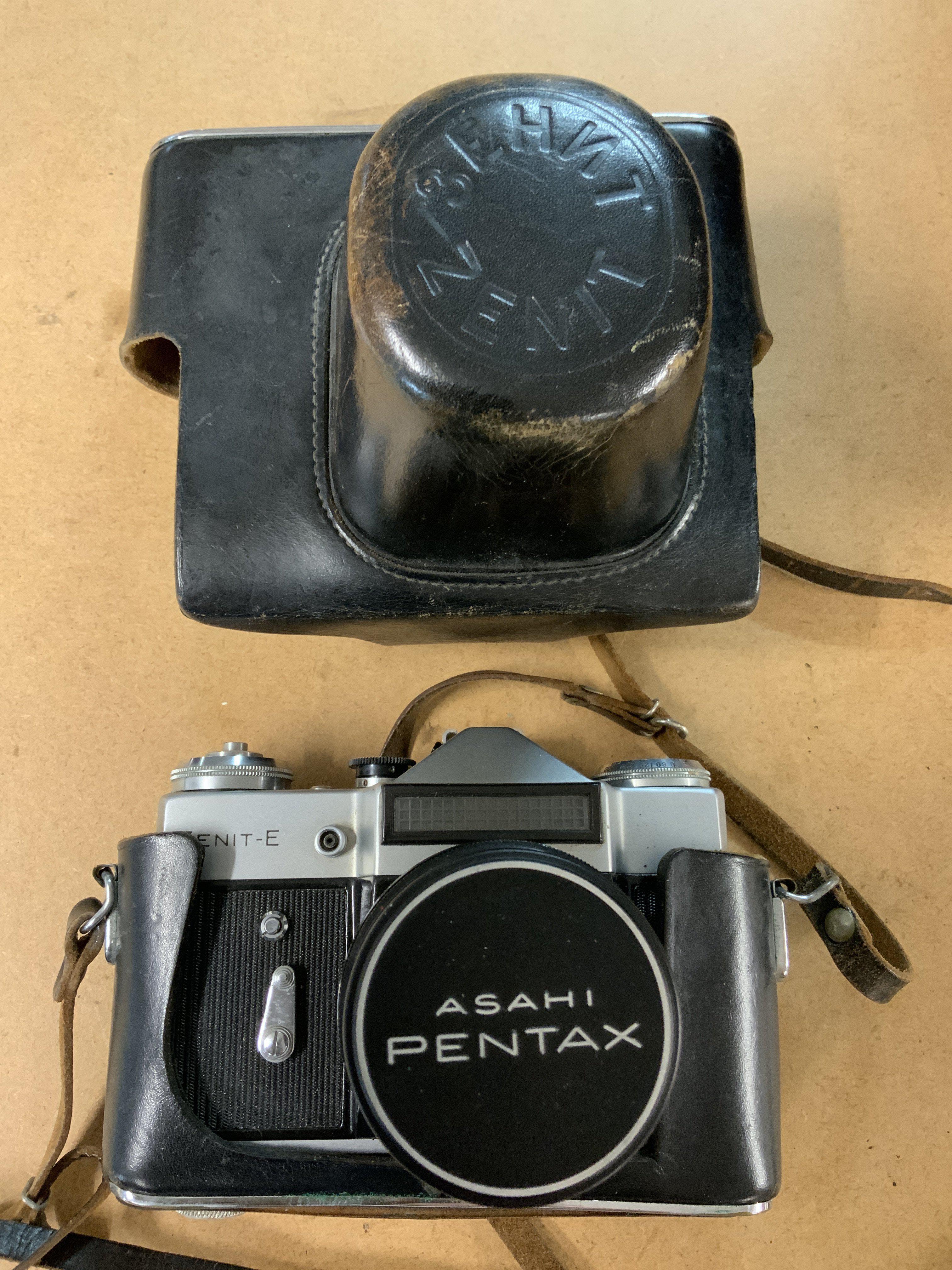 A Zenit - E Soviet SLR camera with attached lense.
