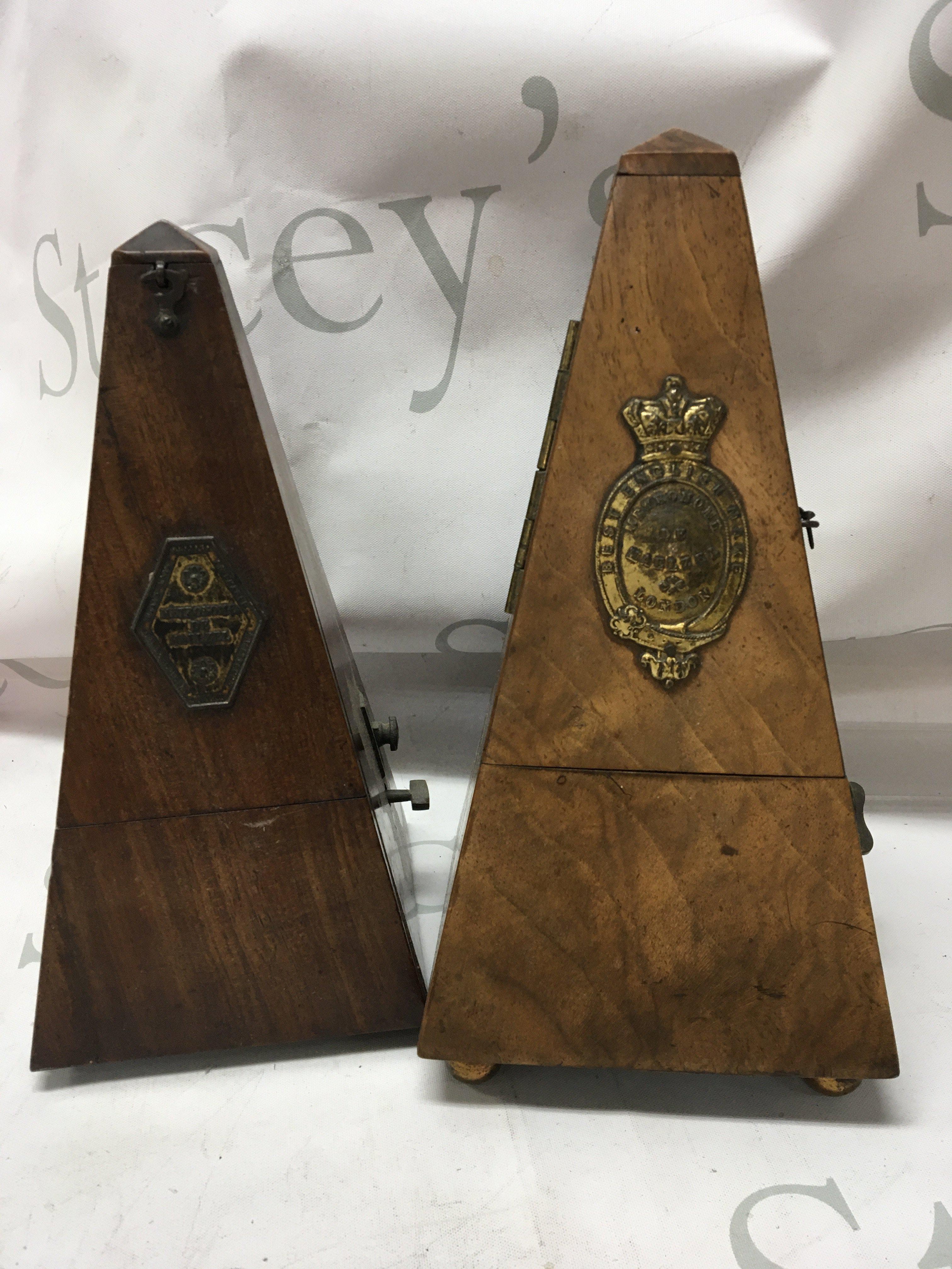 Two walnut cased metronomes .