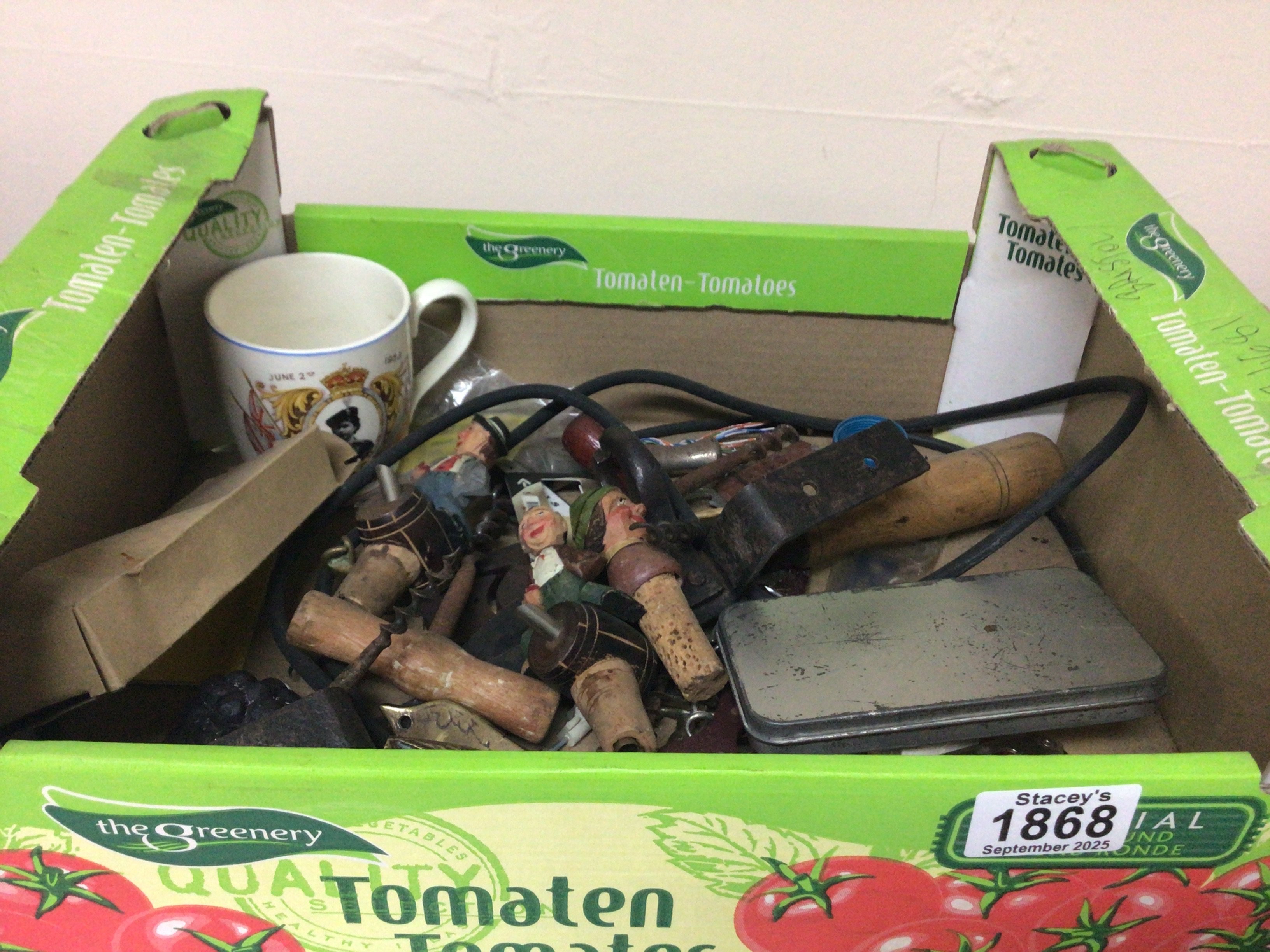 A box containing Vintage carved wood and painted Continental cork bottle tops cork screws and other oddments.