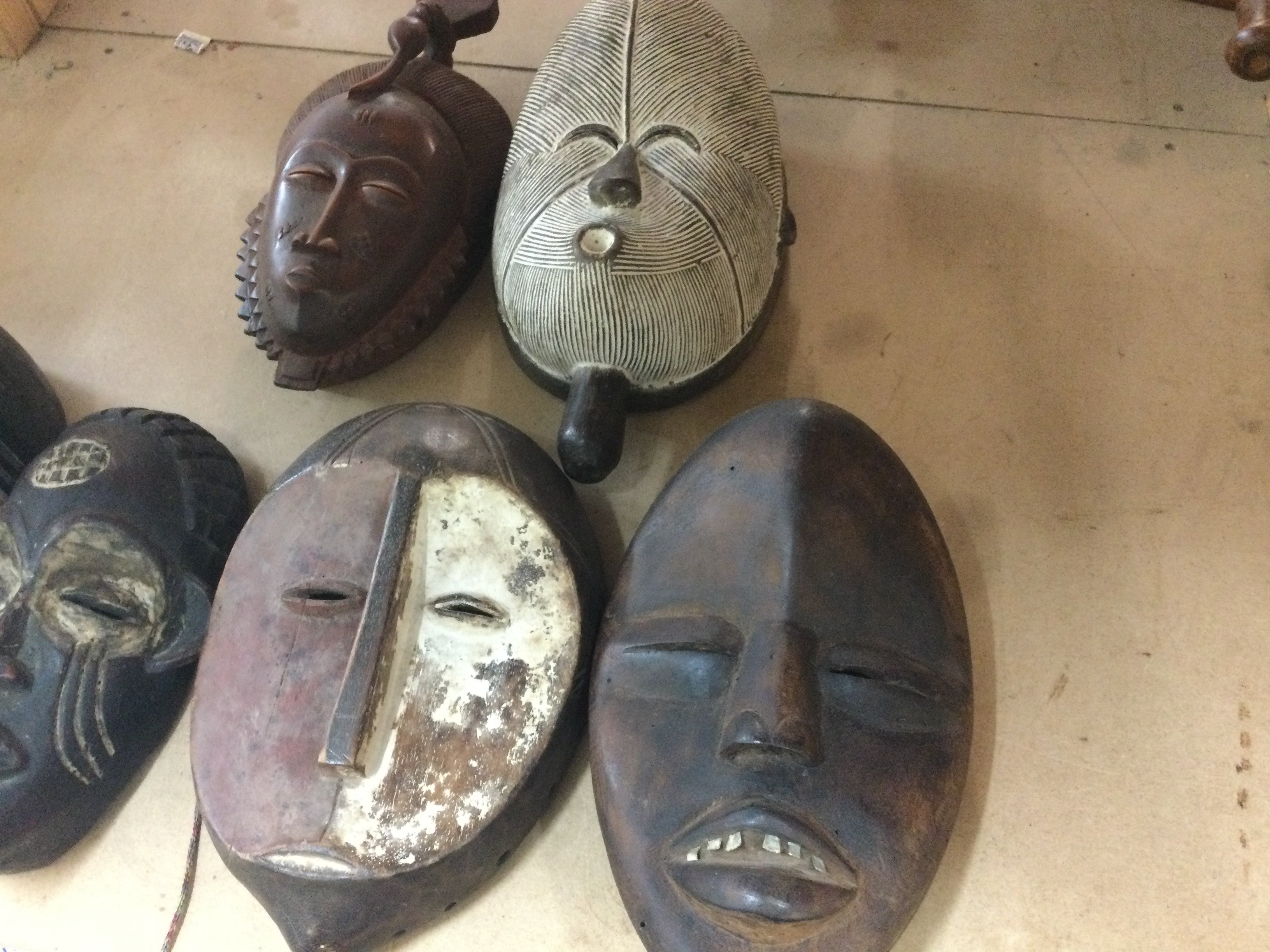 A collection of six triable masks including Republic of Congo , Chokwe and a Dan .