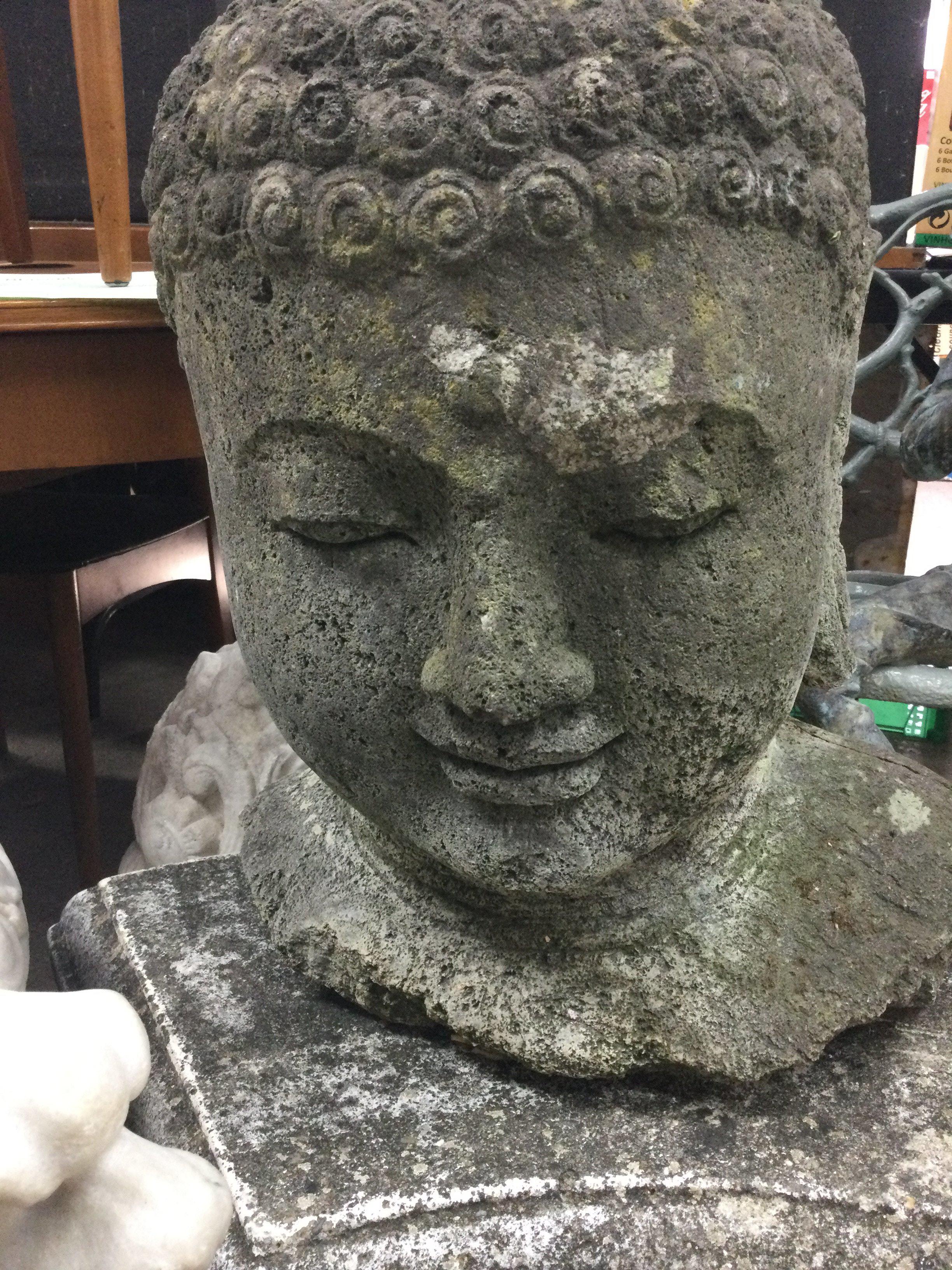 A Carved Buddha/ deity head in basalt. 45 cm .