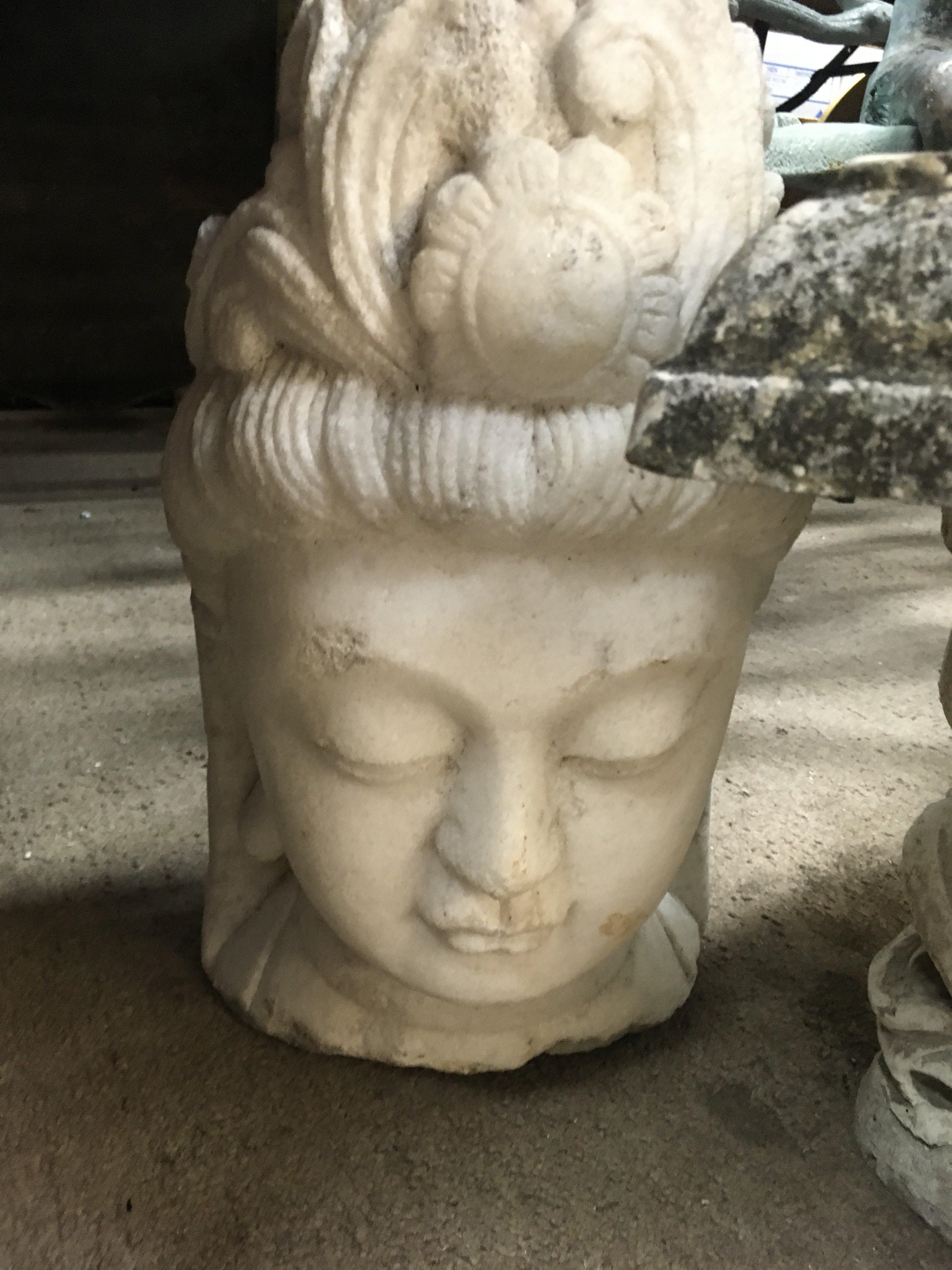 A stone bust carving in the form of a deity . 50 cm .