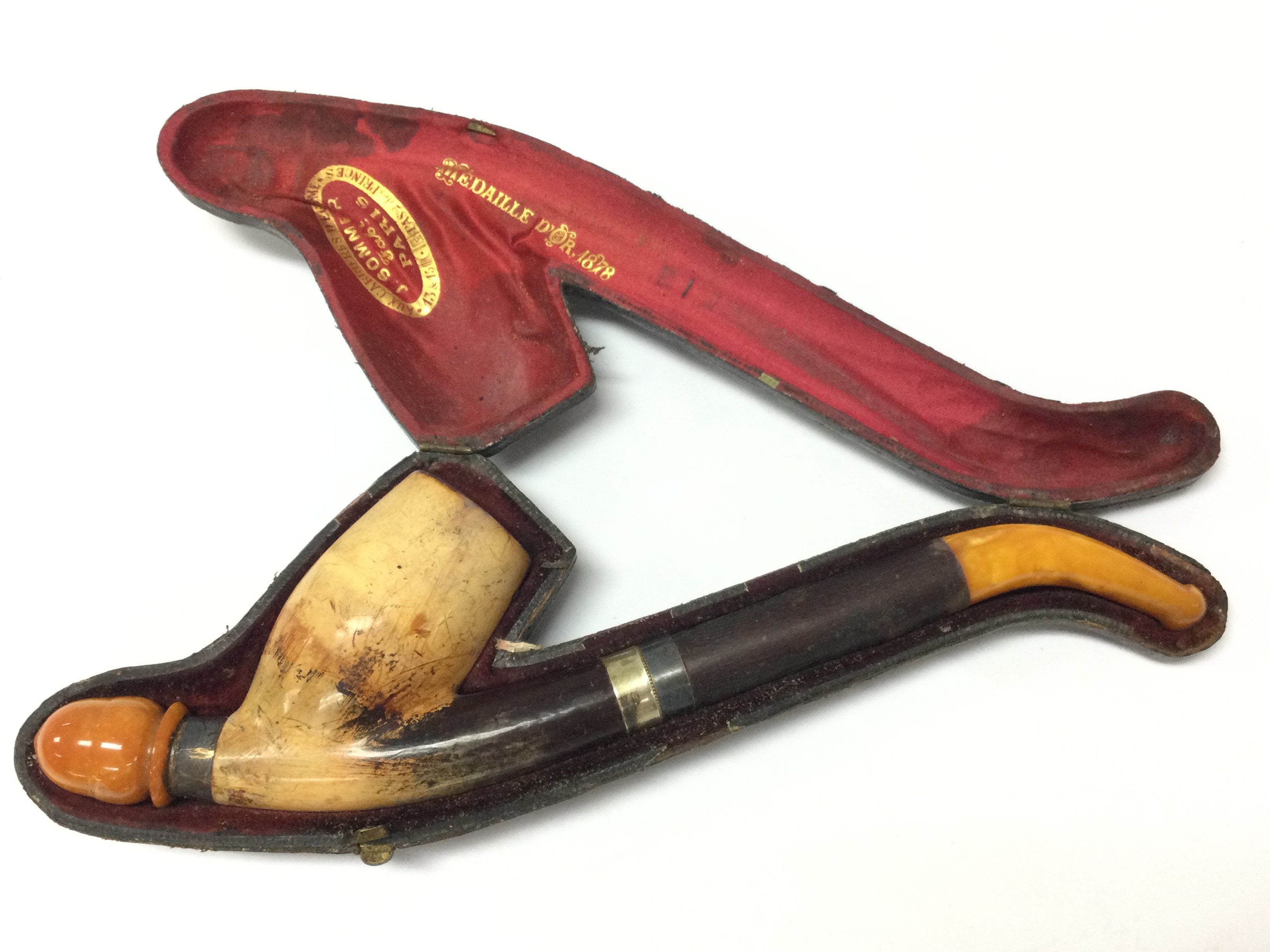 A Victorian pipe with amber mounts in a fitted case. Postage category B