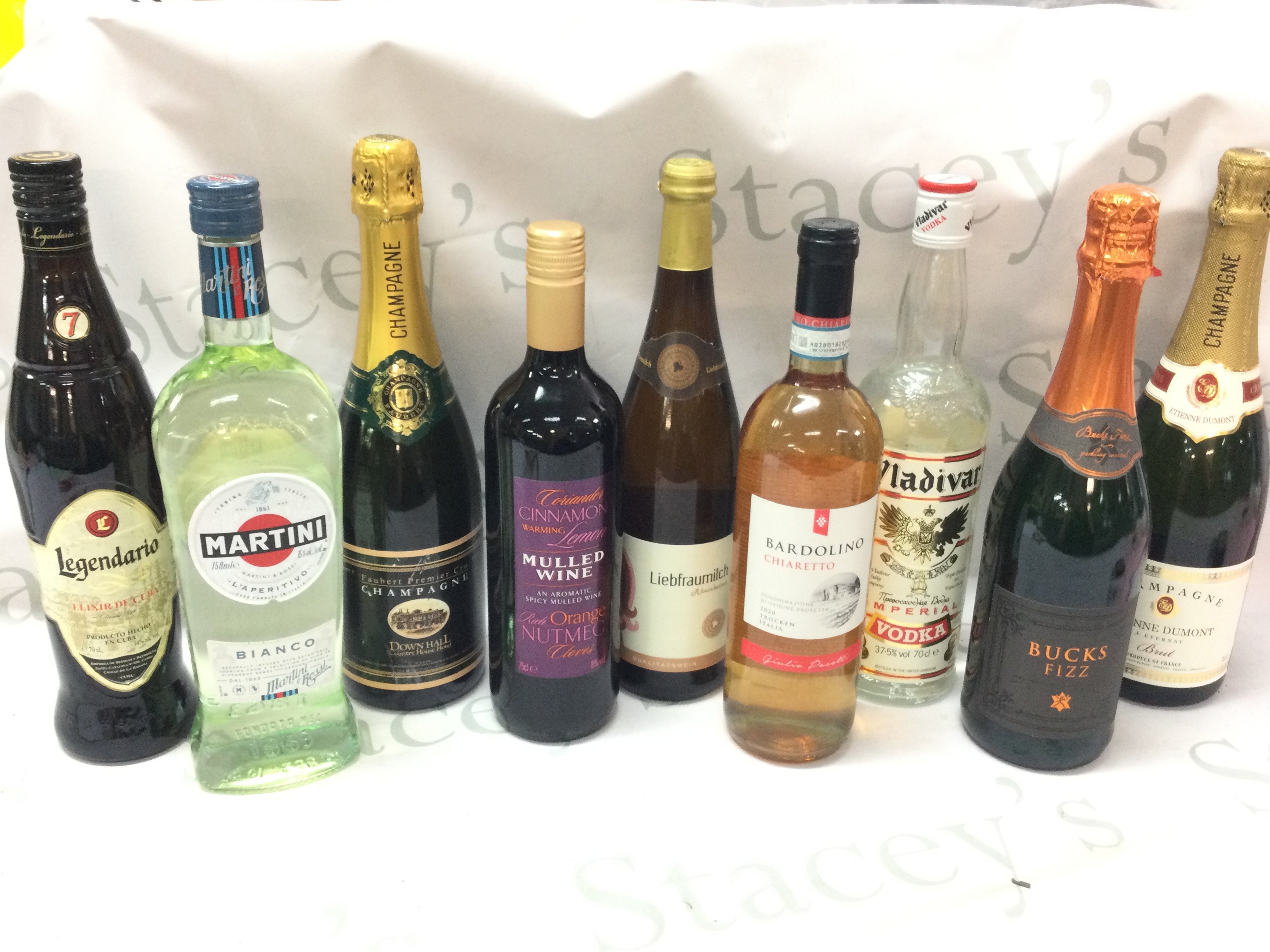 A collection of wine and spirits including Martini , Vladivar Imperial Vodka, Legendario Elixir De Cuba, Faubert Premier Cru Champagne . This lot cannot be posted