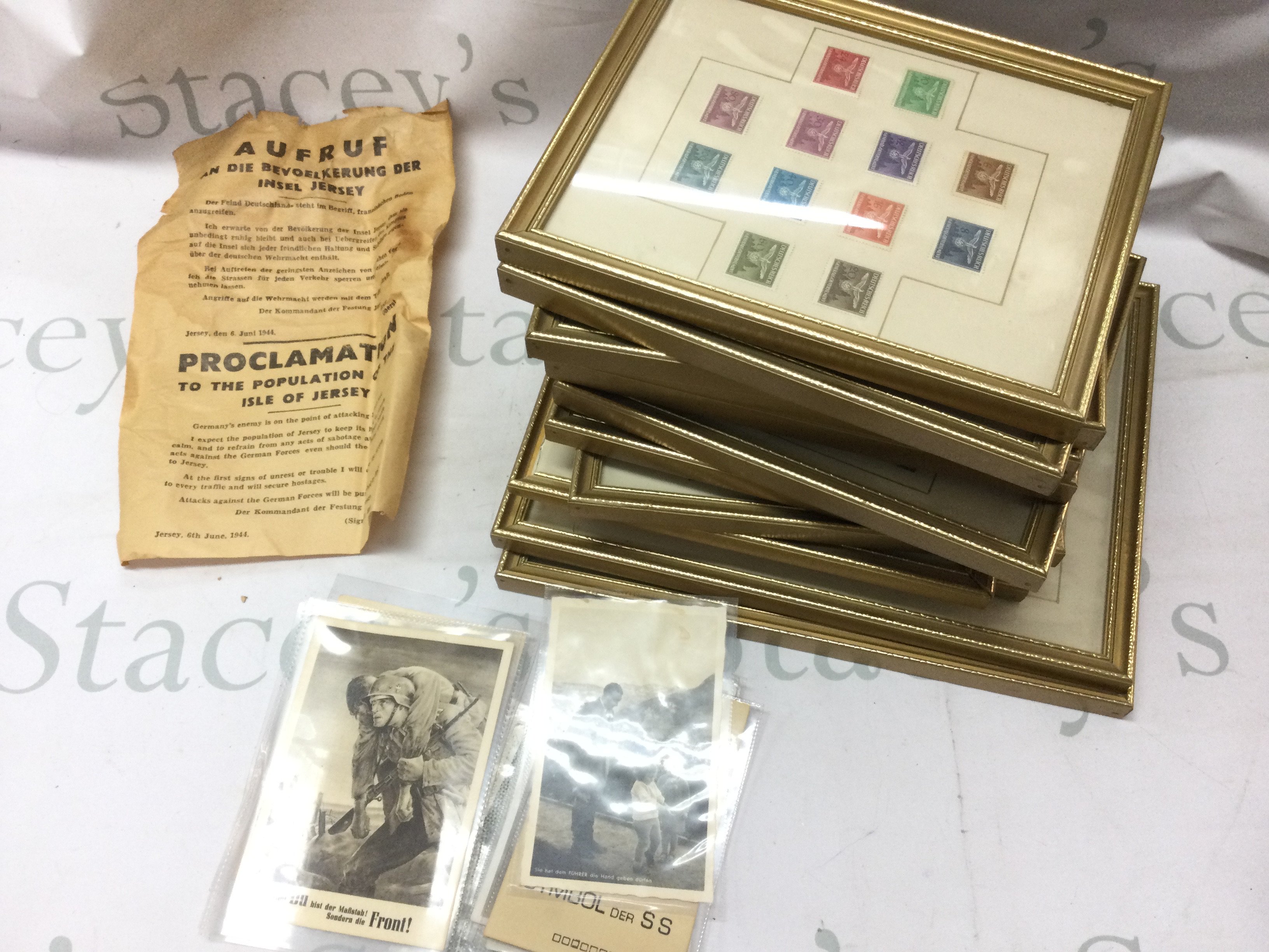 A collection of framed unused and used German Third Reich stamps, Proclamation to the population of the isle of jersey and postcards . This lot can be posted without frames.