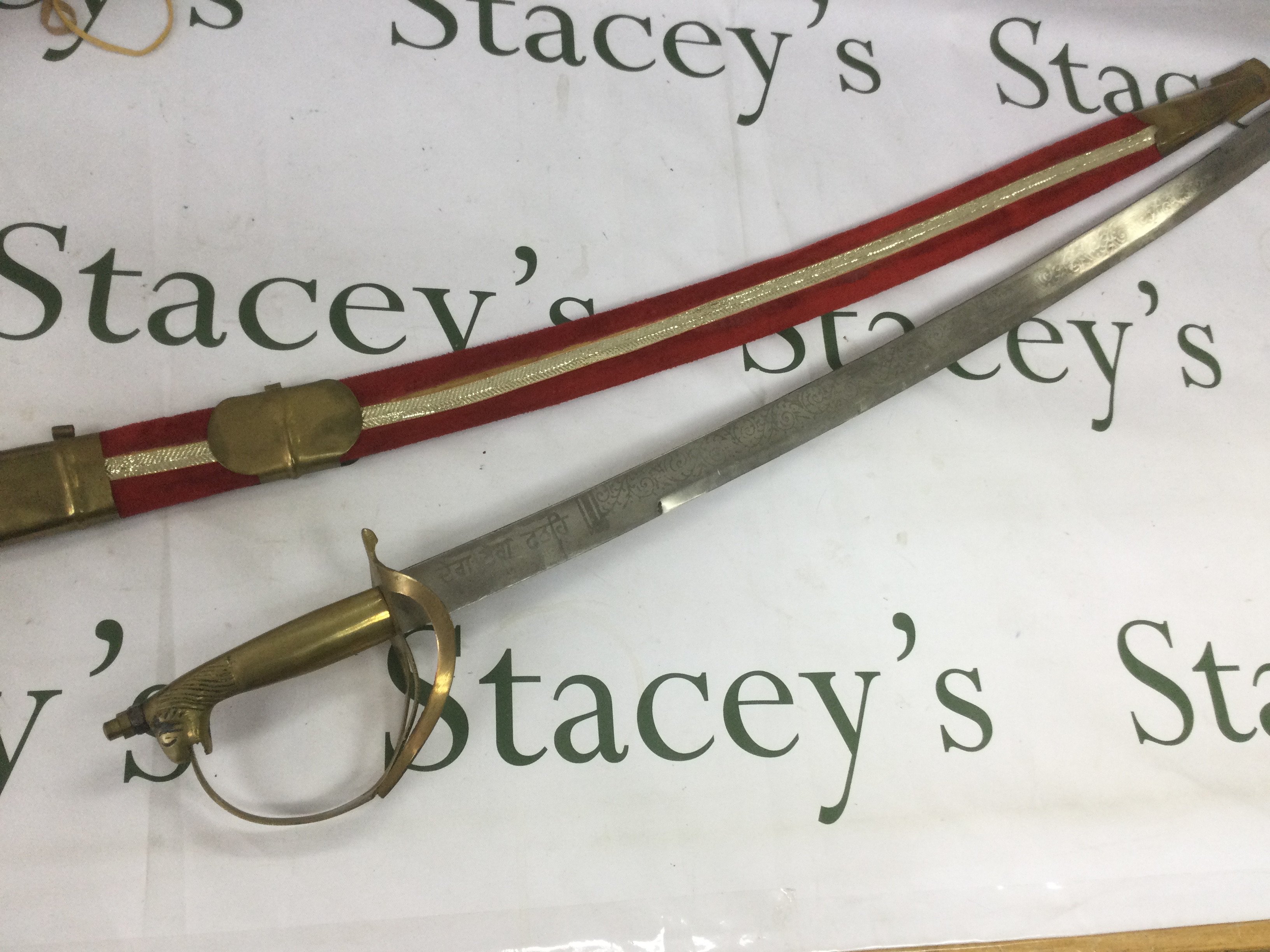 A boxed Milbro air gun and an Indian sword (2). Shipping category D.