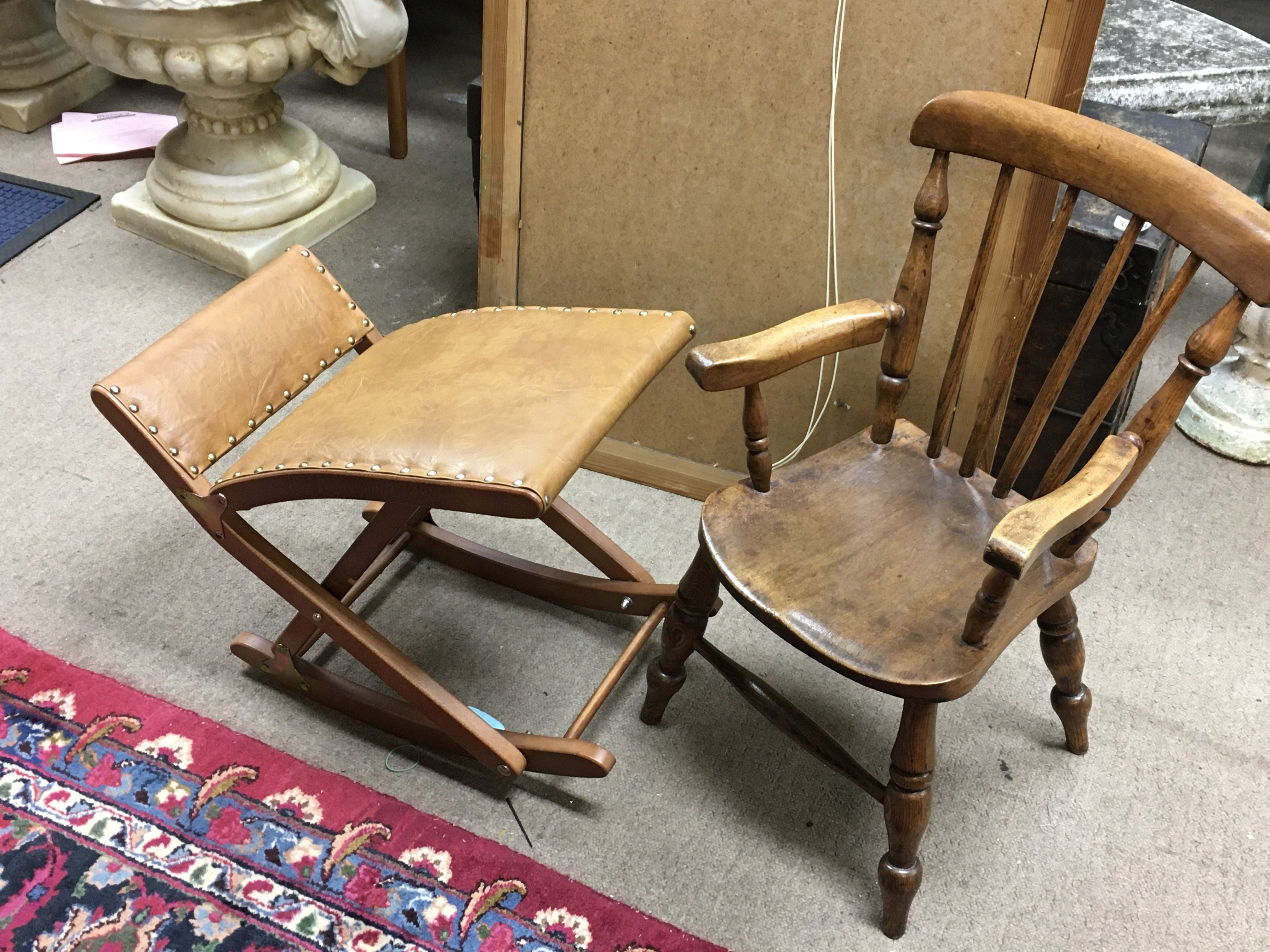 A small childrens chair and a leather and wooden stool.