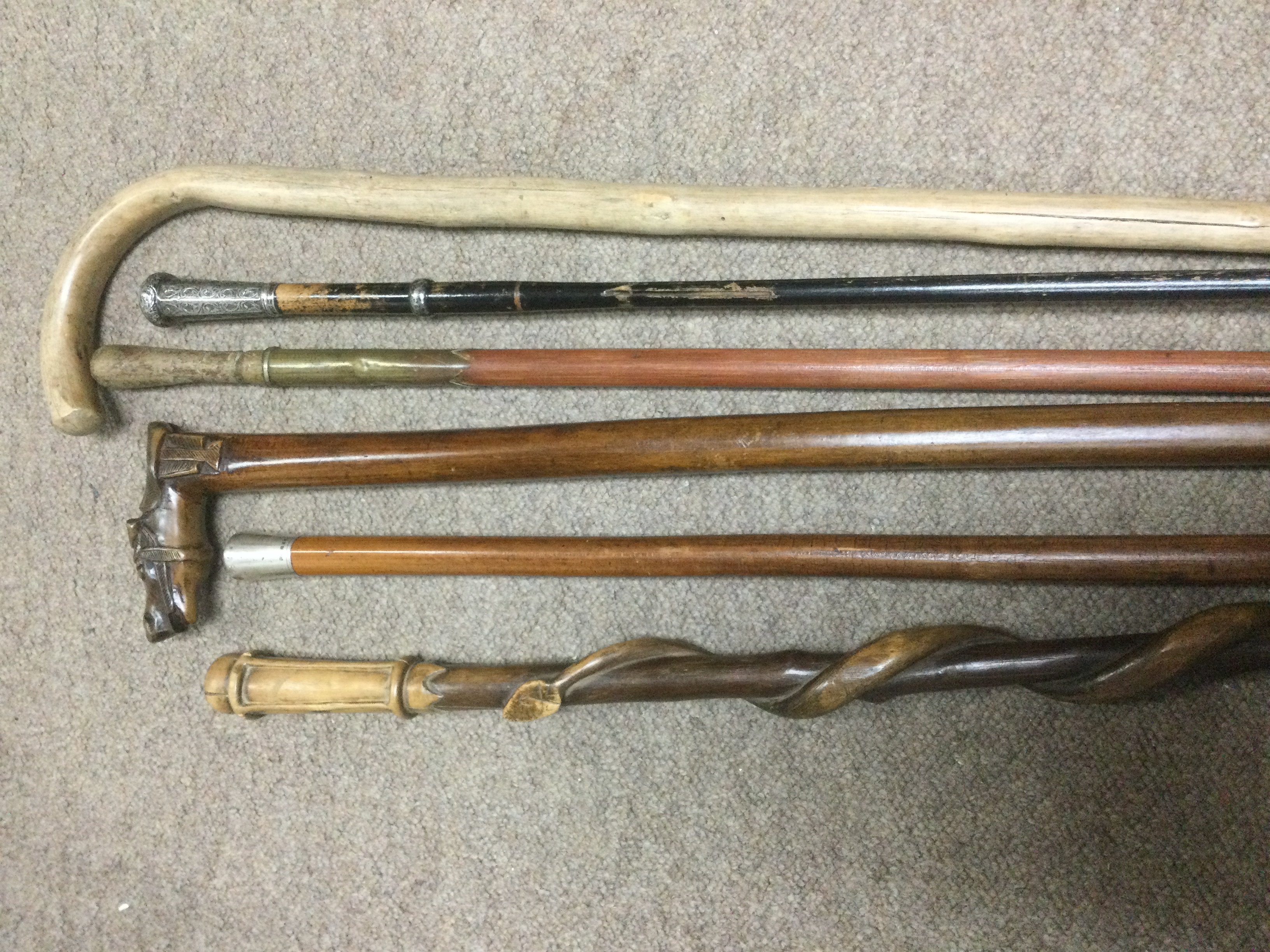 Six walking canes including two with silver mounts. Shipping category D.