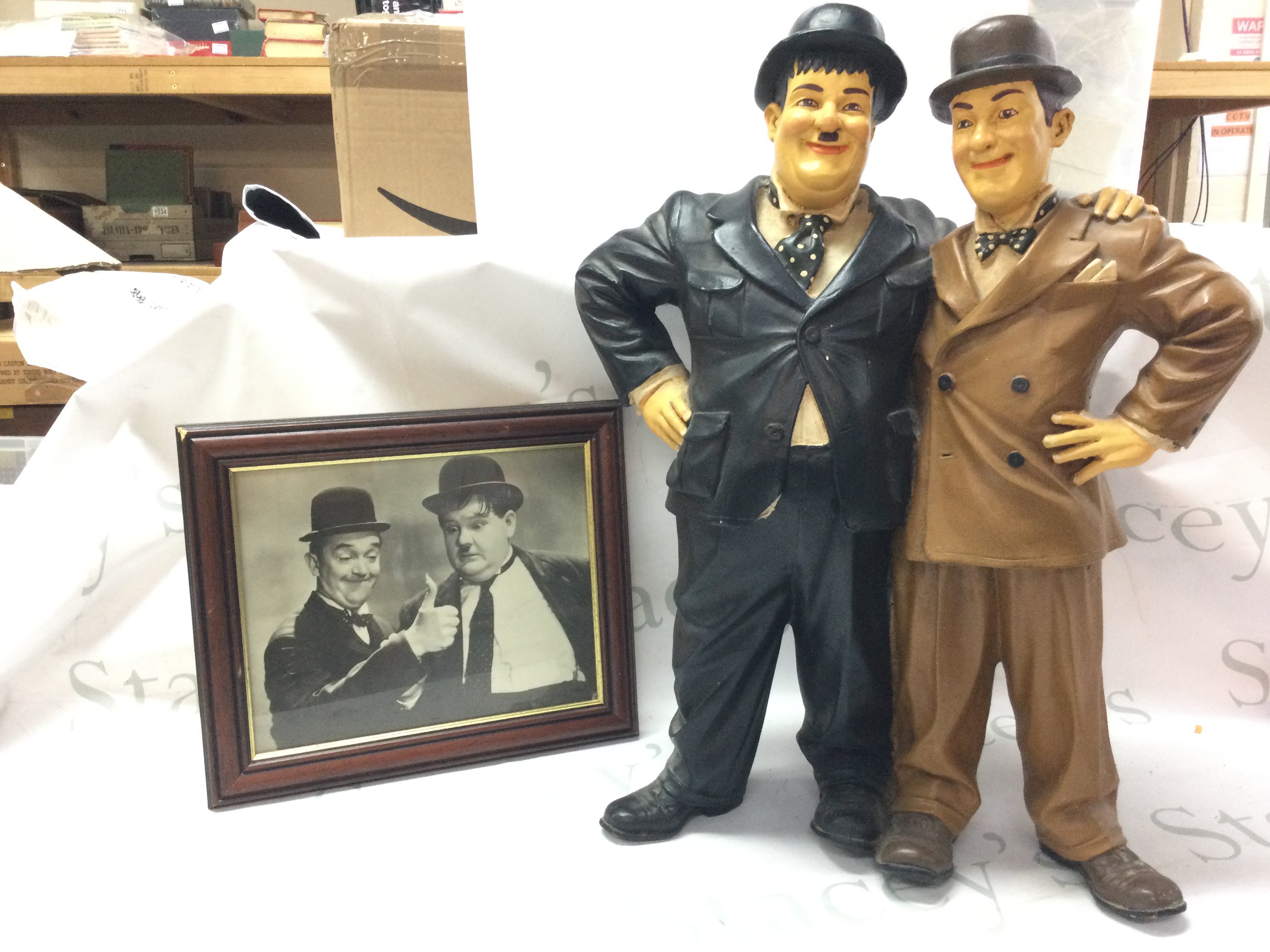 A Laurel And Hardy figure group and a framed photo