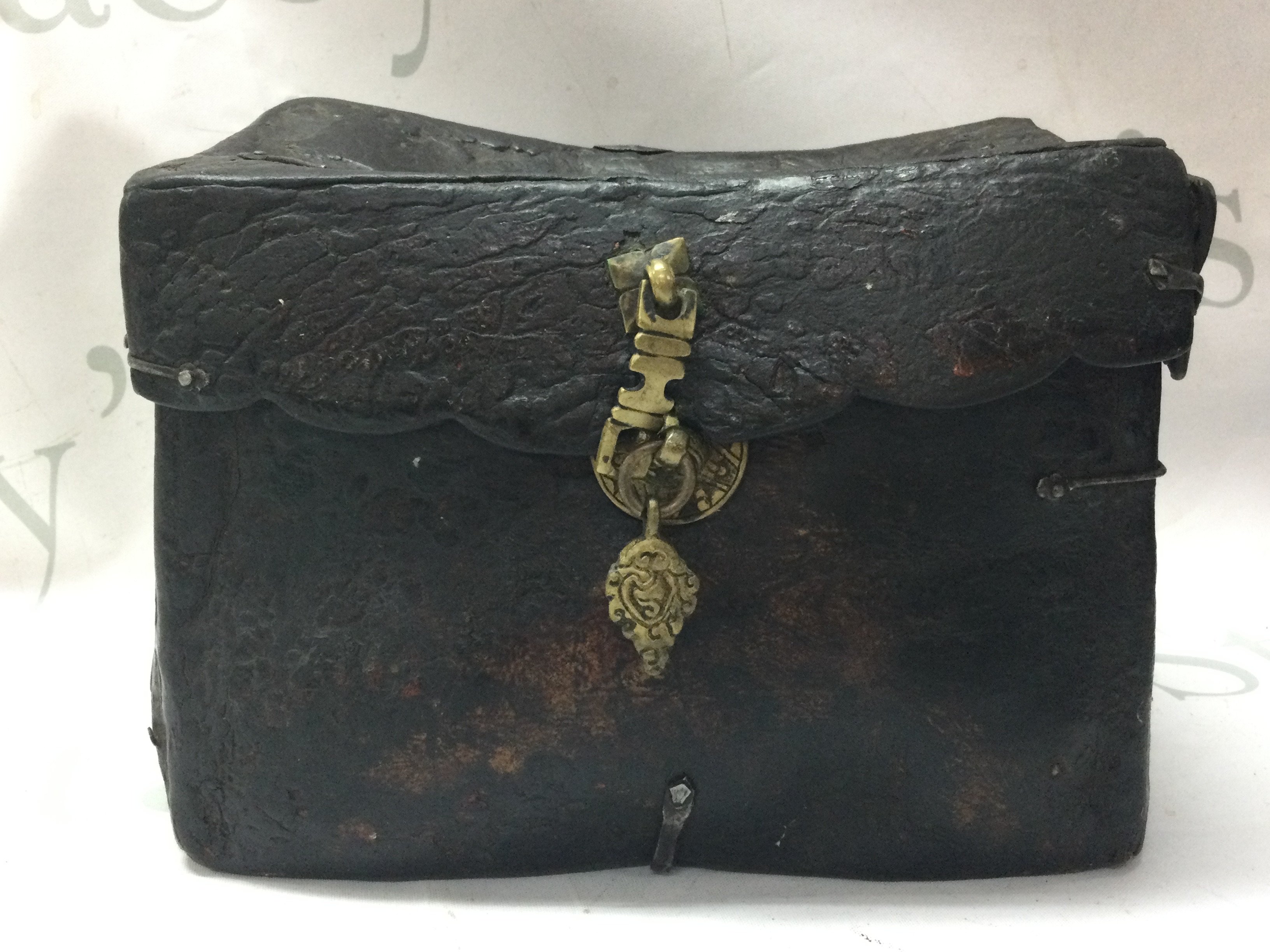 A Tibetan Yak Skin and iron bound saddle box 16cm tall 21cm wide 13cm long approx . Postage category C