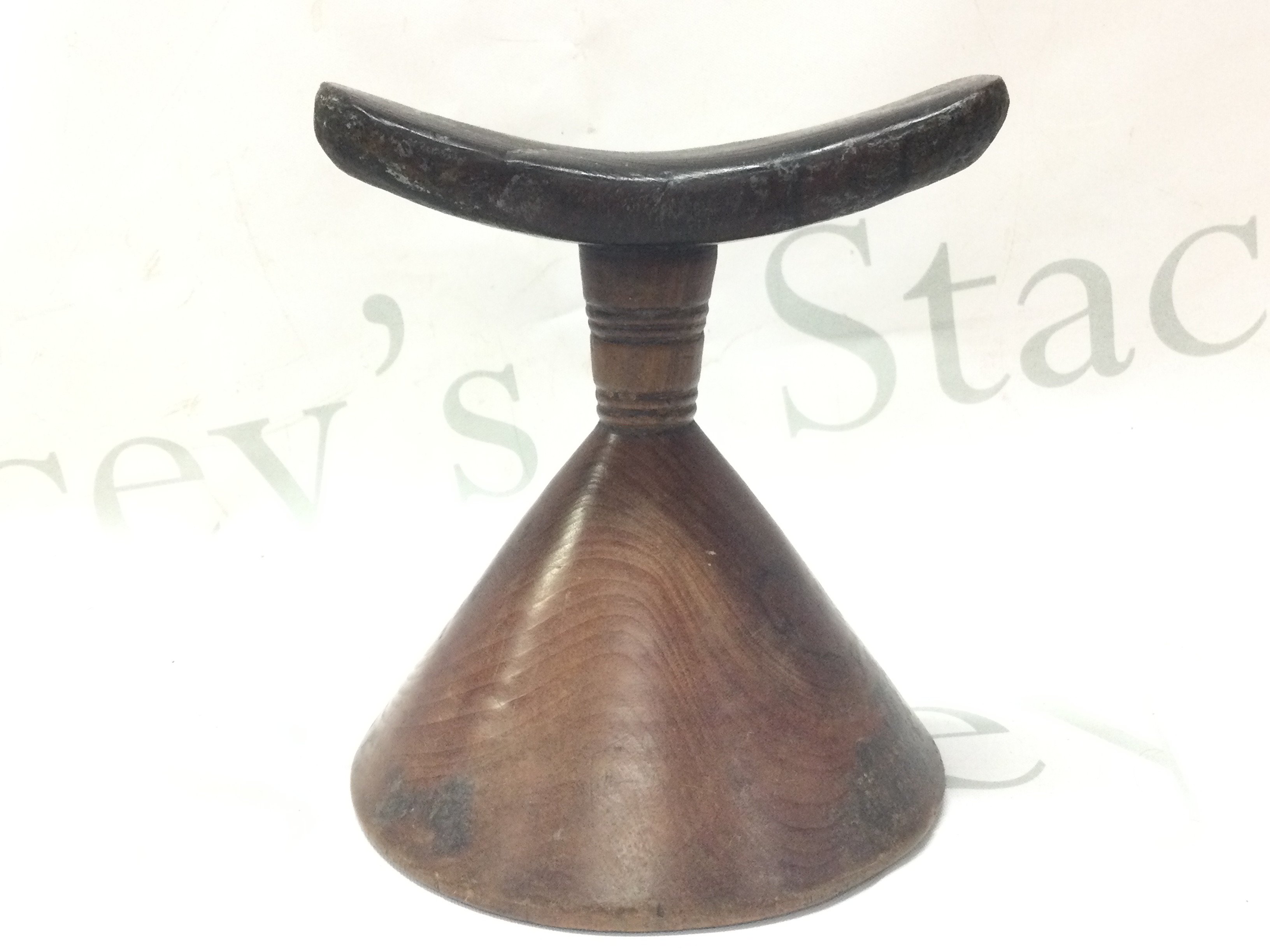 An Ethiopian wooden pillow. 14cm tall. Postage category B