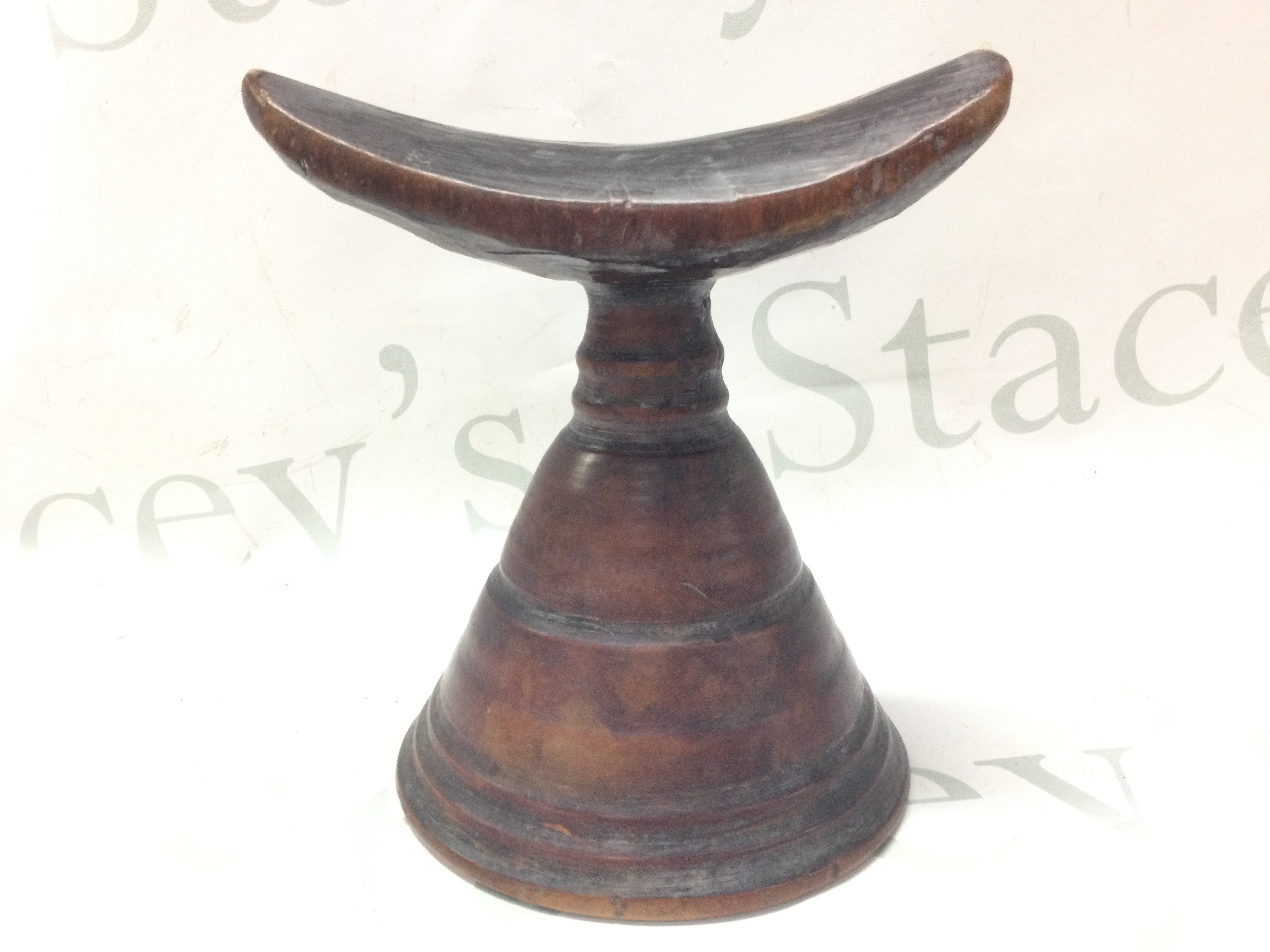 An Ethiopian wooden pillow. 15cm tall. Postage category B