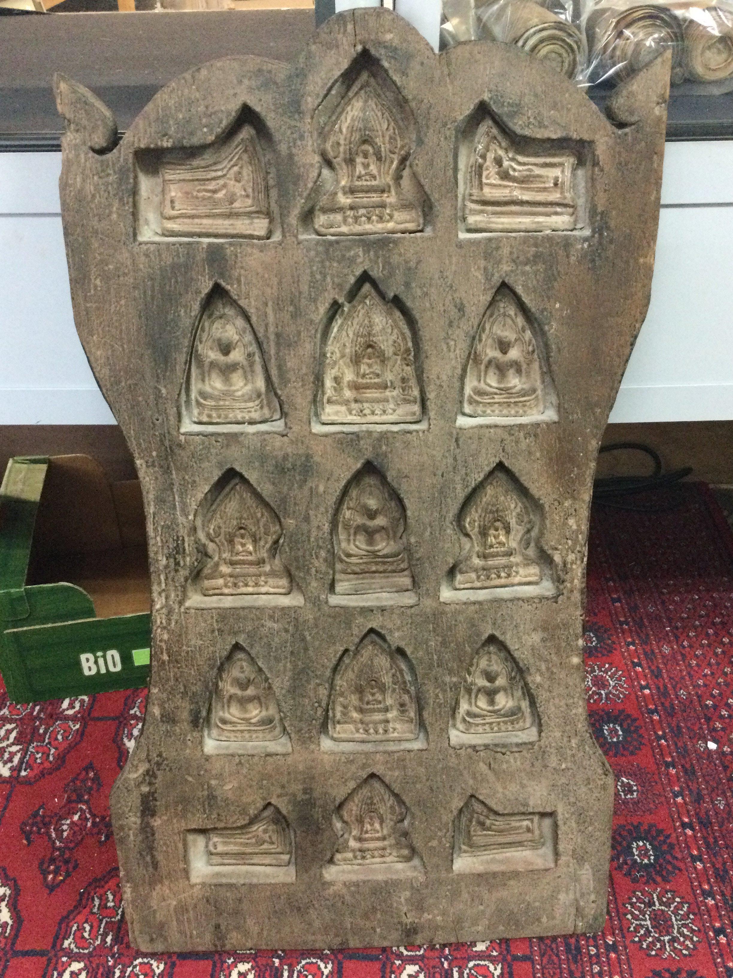 A large Tibetan wooden shrine with inset reliefs. 41cm wide 80cm tall.