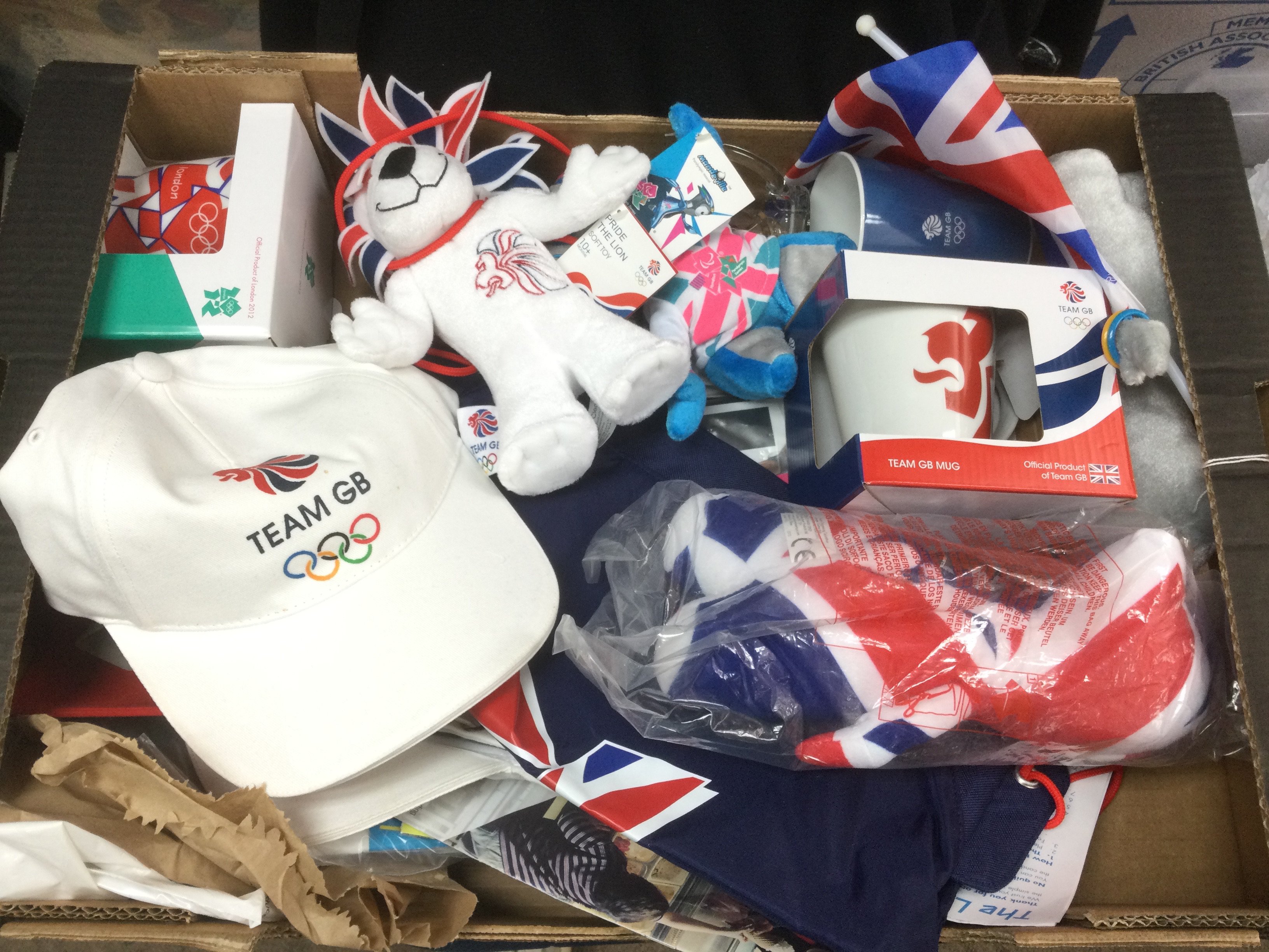 Two boxes of 2012 London Olympics and 2002 Manchester Commonwealth games memorabilia and ceramics. Shipping category D.