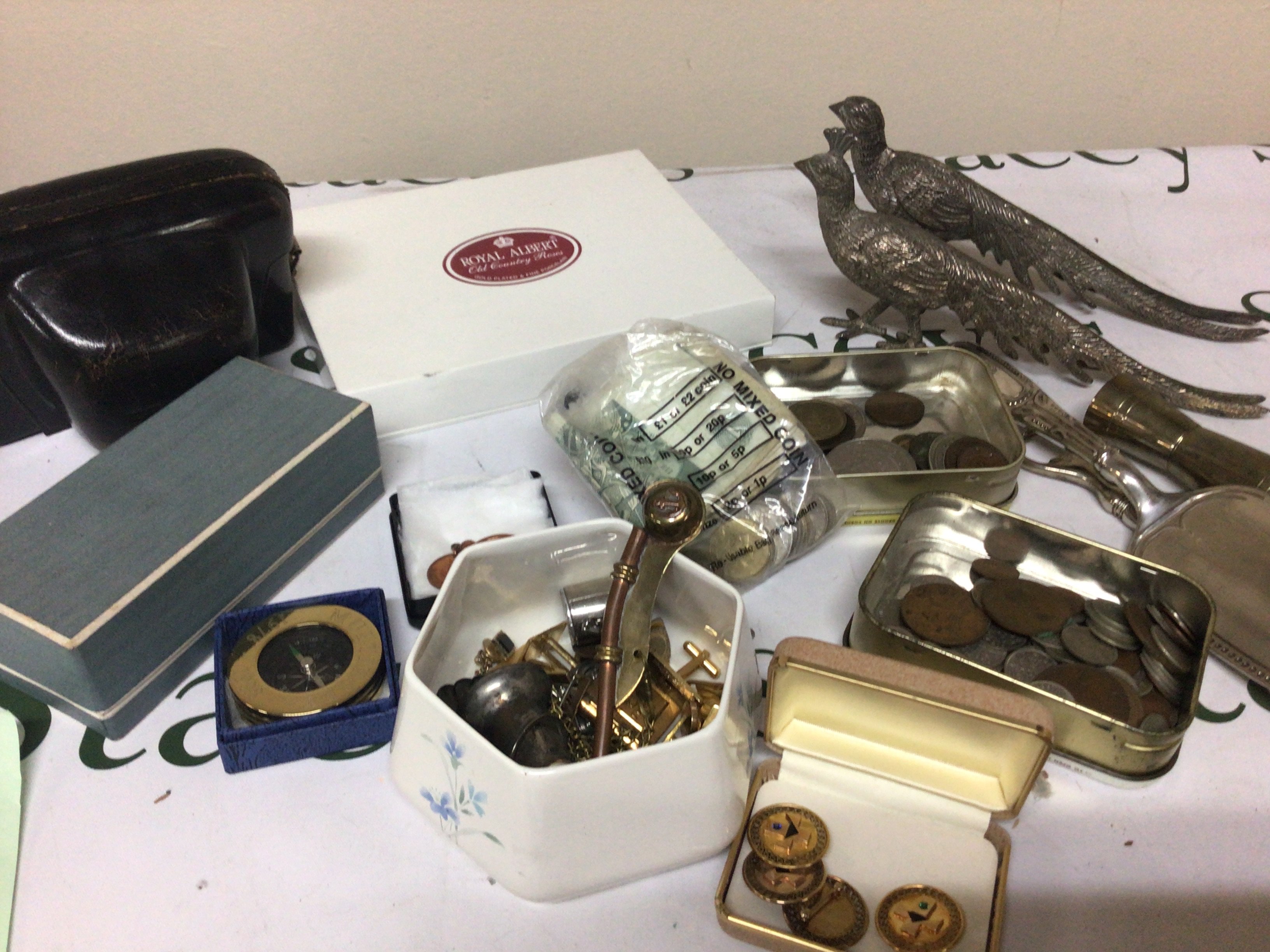 A collection of oddments comprising coins four 12carat gold filled brooches camera a Bosons whistle and other ornaments.