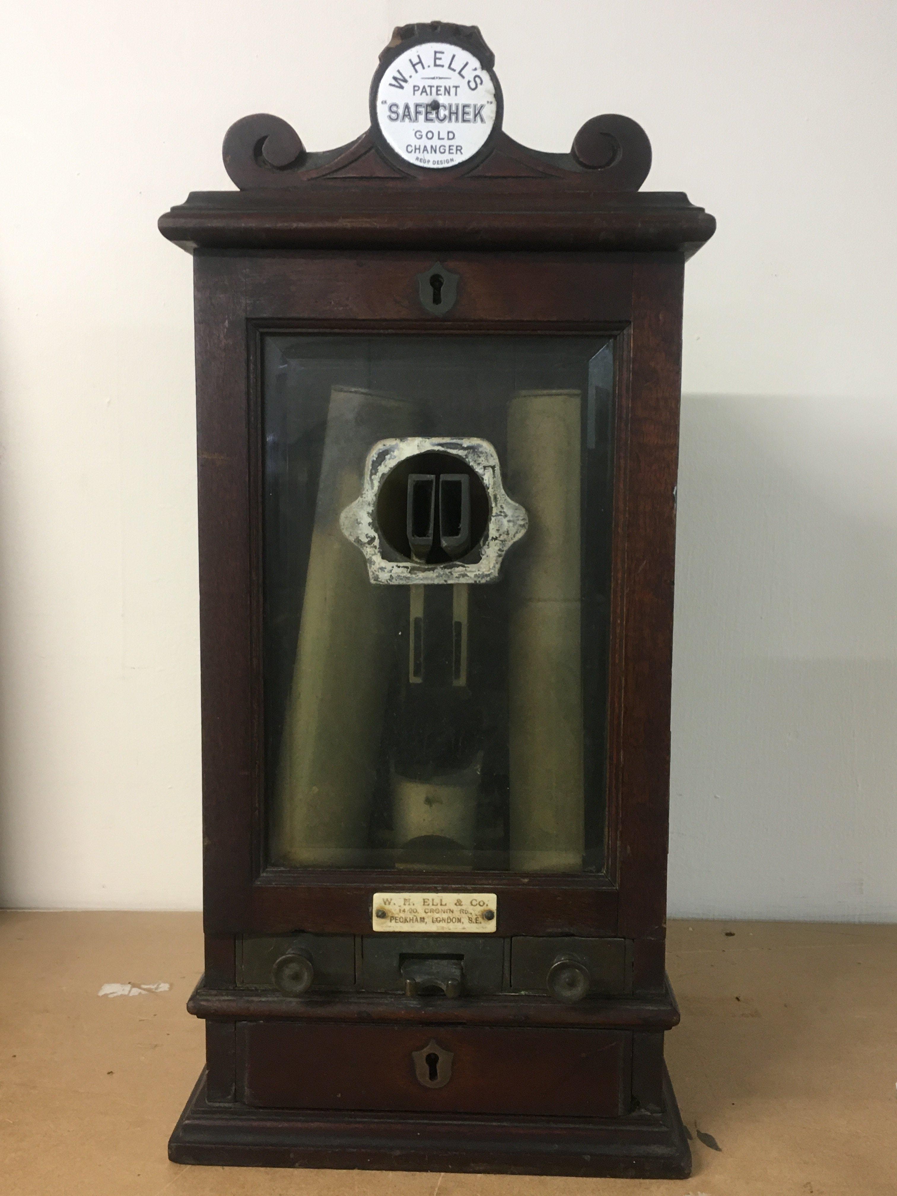 A Victorian W.H Ell & Co Safechek Gold changer . 45cm tall this lot cannot be posted