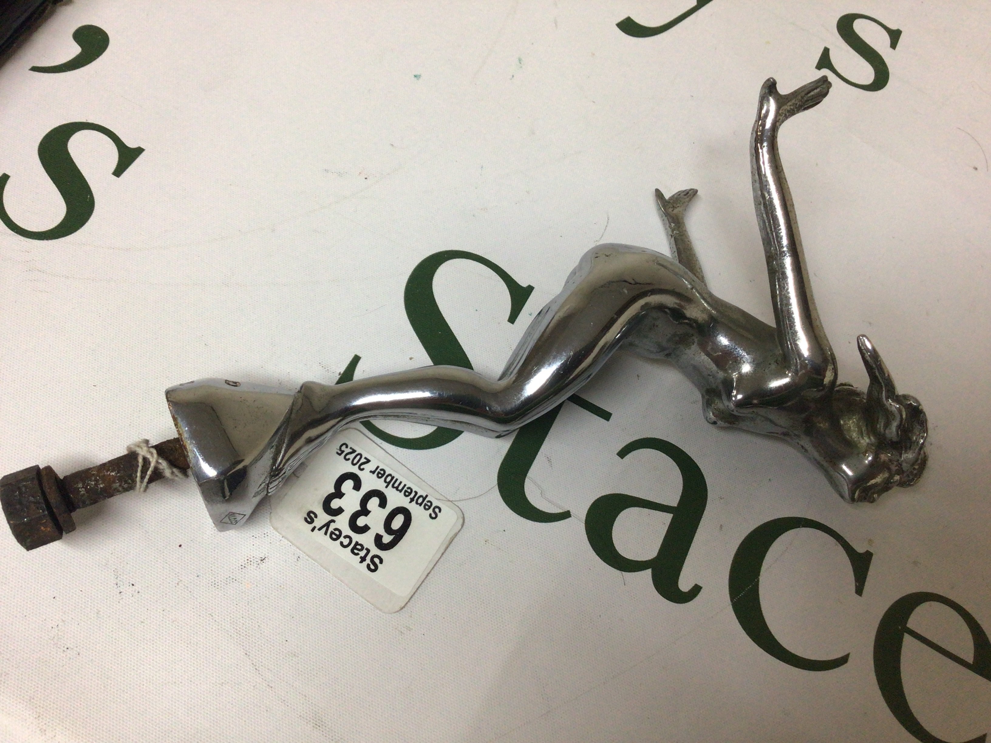 A 1920/30 solid cast metal and Chrome plated car mascot a diving naked nymph with flowing hair makers stamp NLCCo with fitting attached total length 21cm.