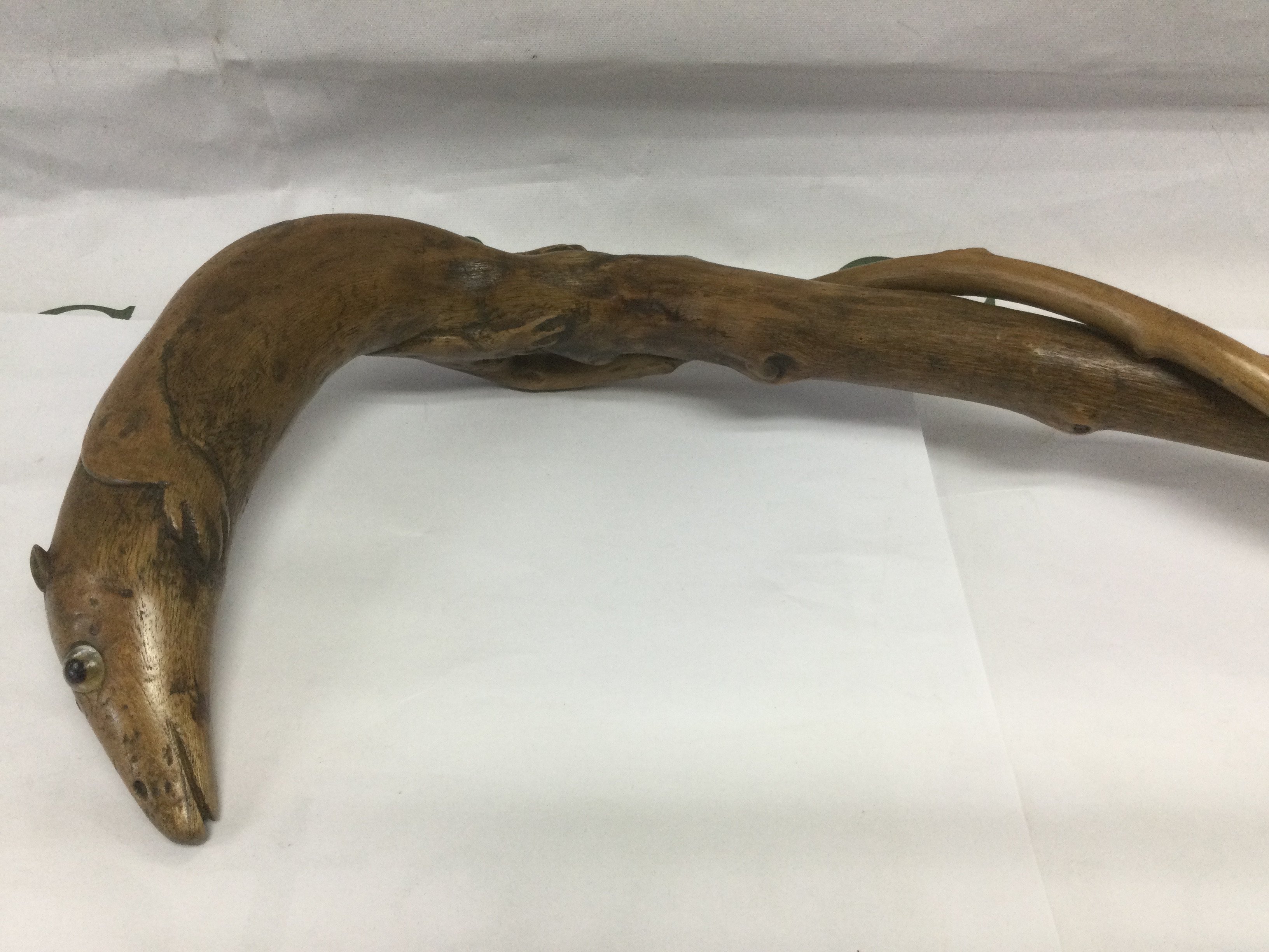 A walking cane, the handle in the form of a rodent like creature, the elongated tail winding around the shaft of the stick, approx total length 88cm. Shipping category D.