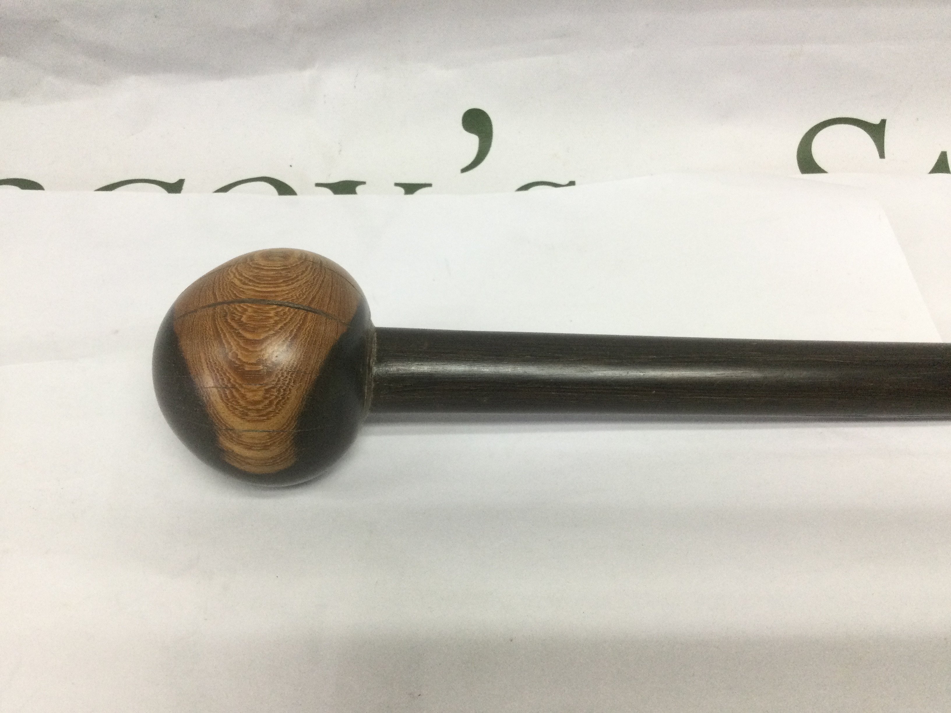 A walking cane with circular handle, approx total length 87.5cm. Shipping category D.