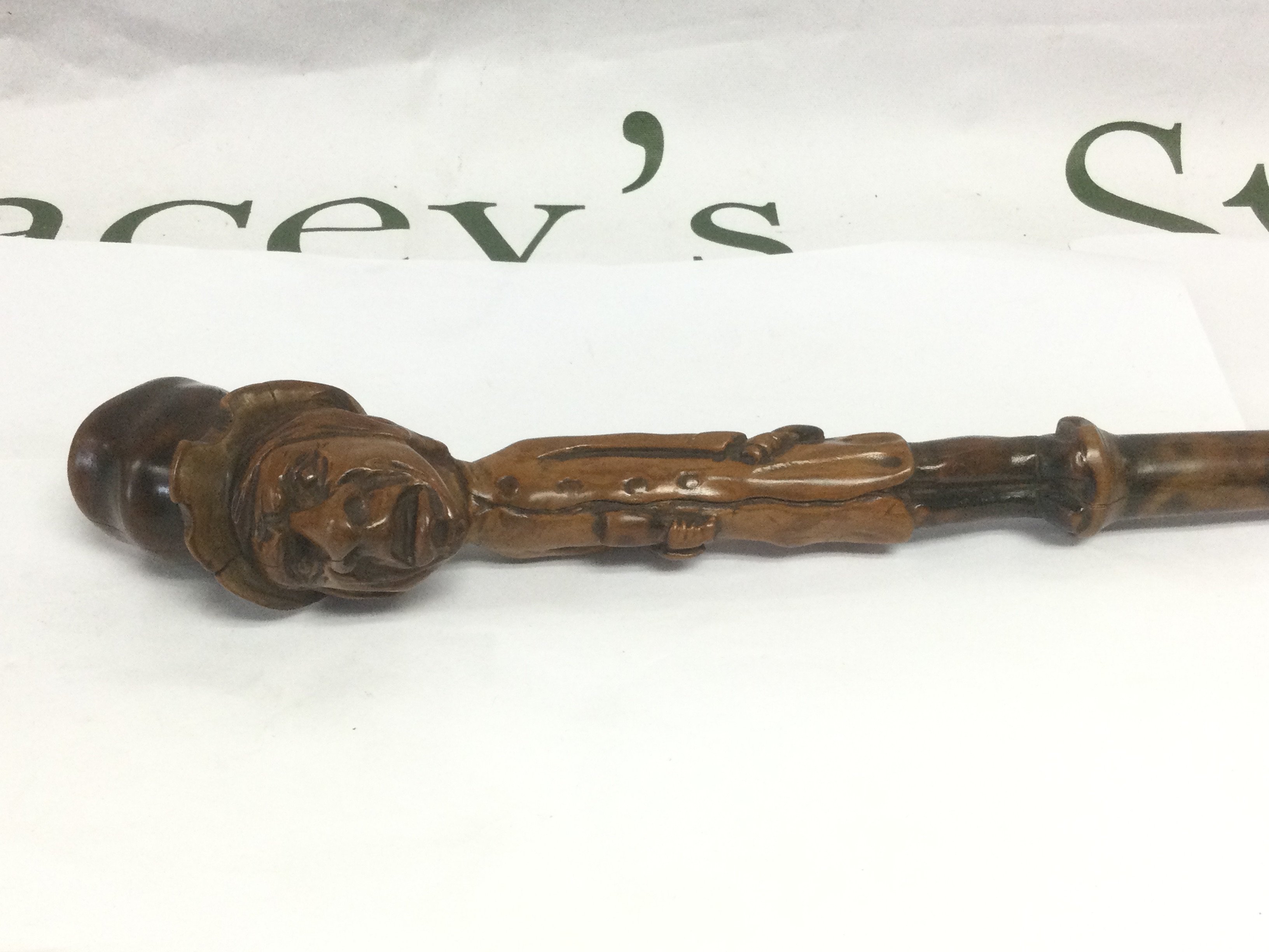 A walking cane, the handle carved in the form of a Dickensian type character, approx total length 90cm. Shipping category D.