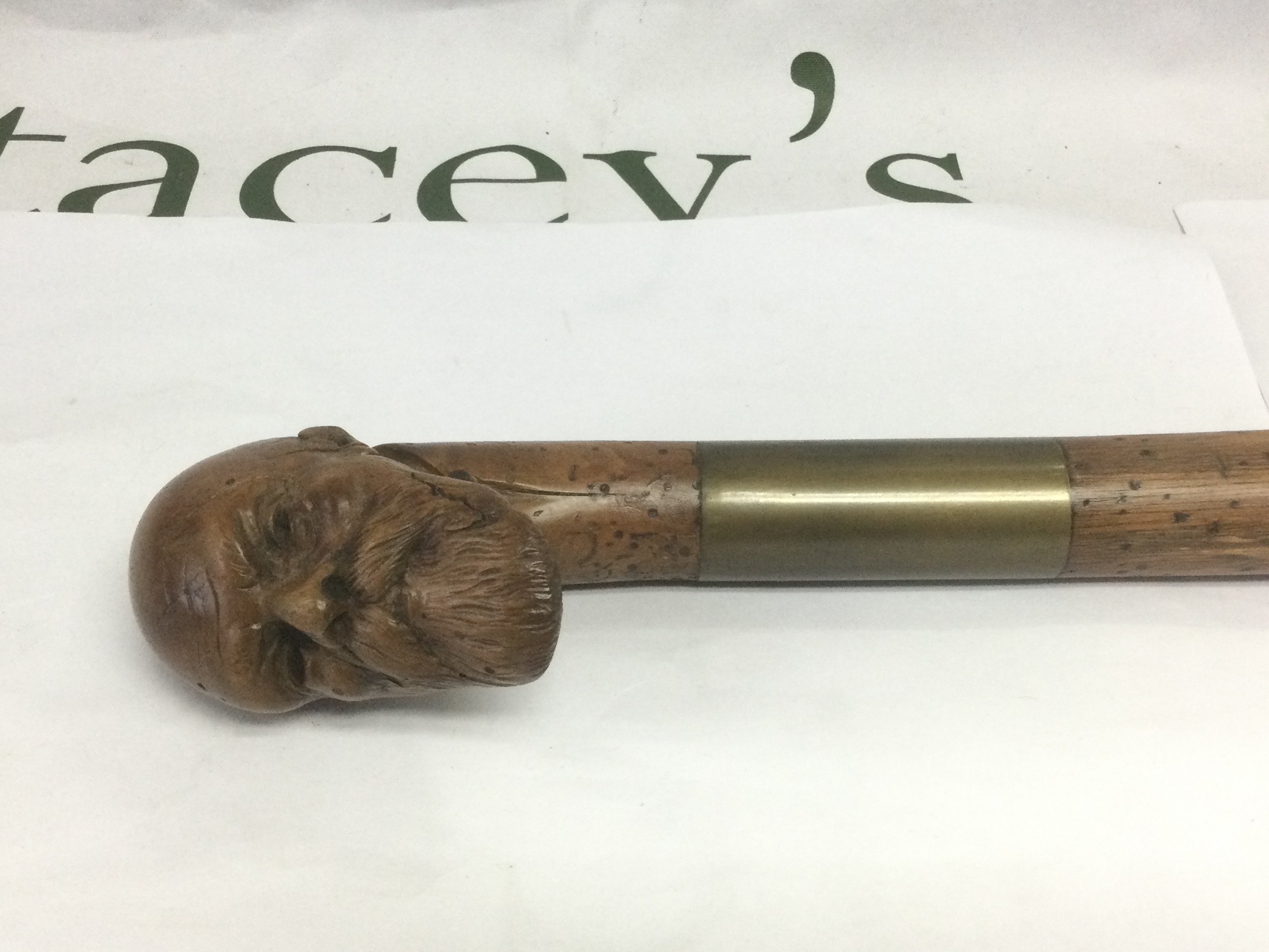 A walking cane, the handle carved in the form of the head of a bearded gentleman, approx total length 85cm. Shipping category D.