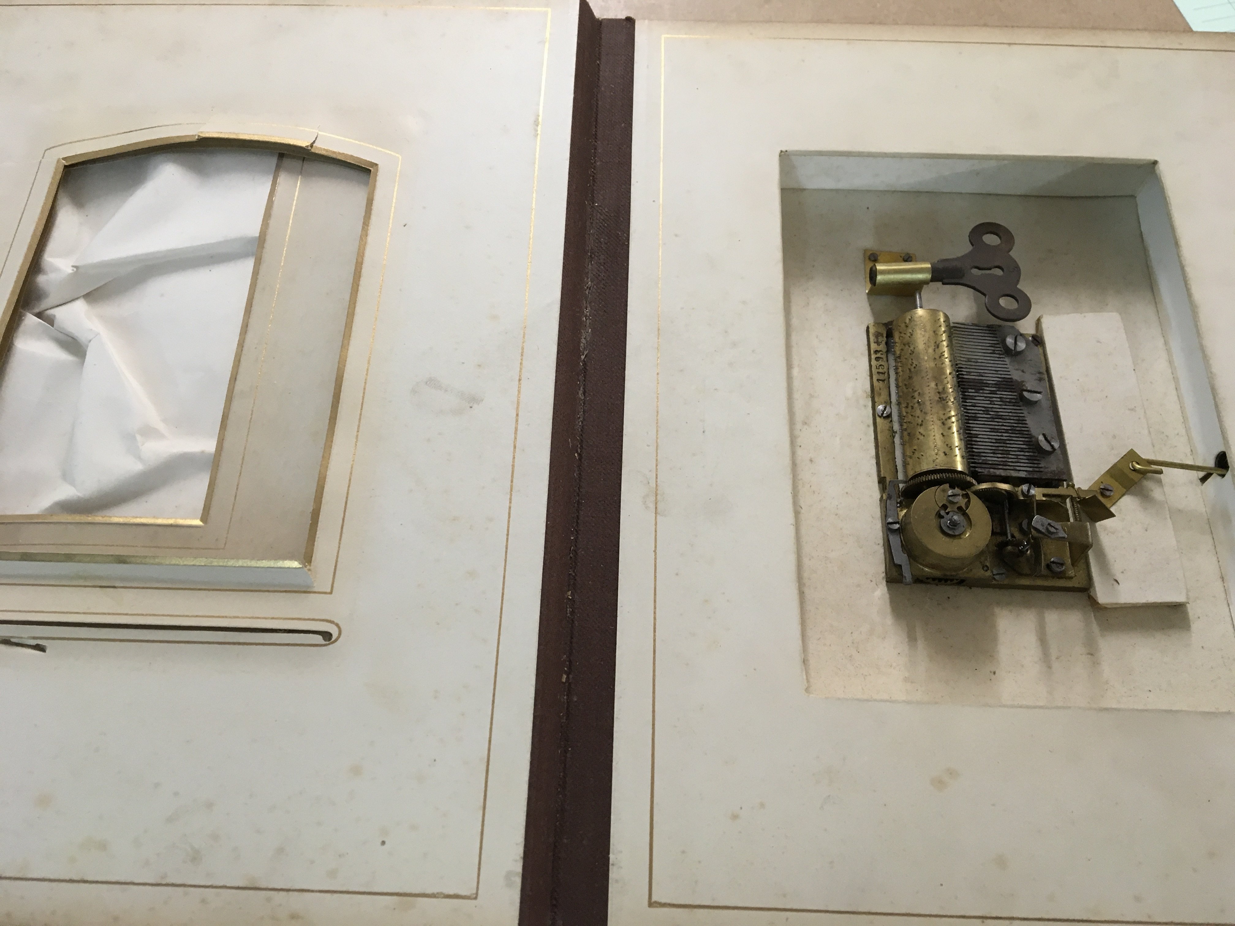 A Victorian photo Album inset with a music box .