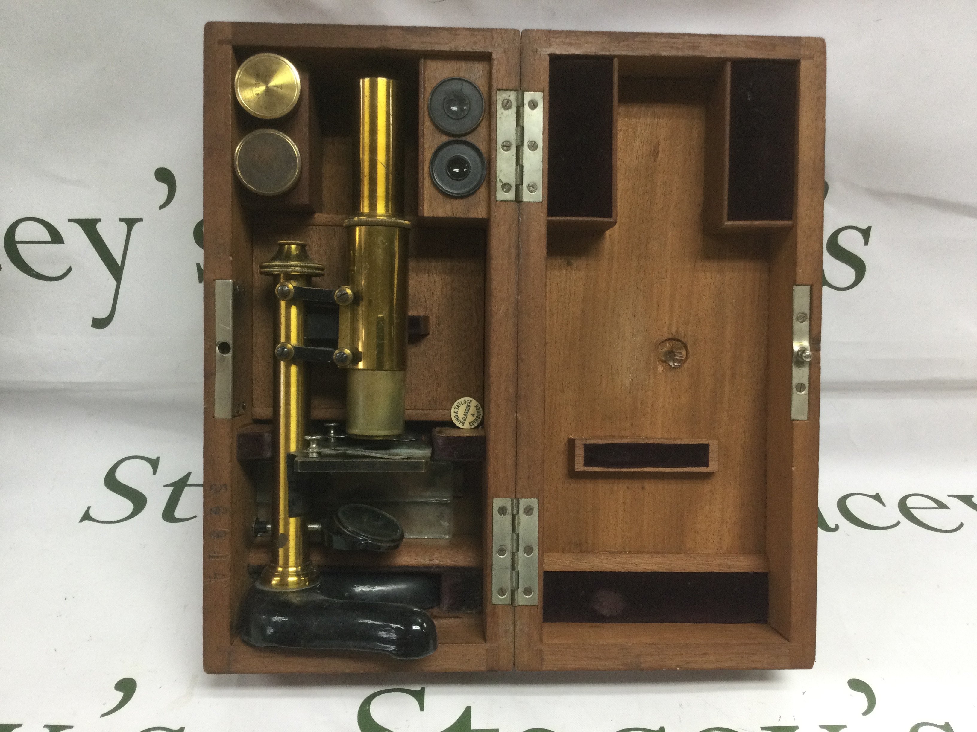 A cased Baird & Tatlock microscope and lenses. Shipping category D.