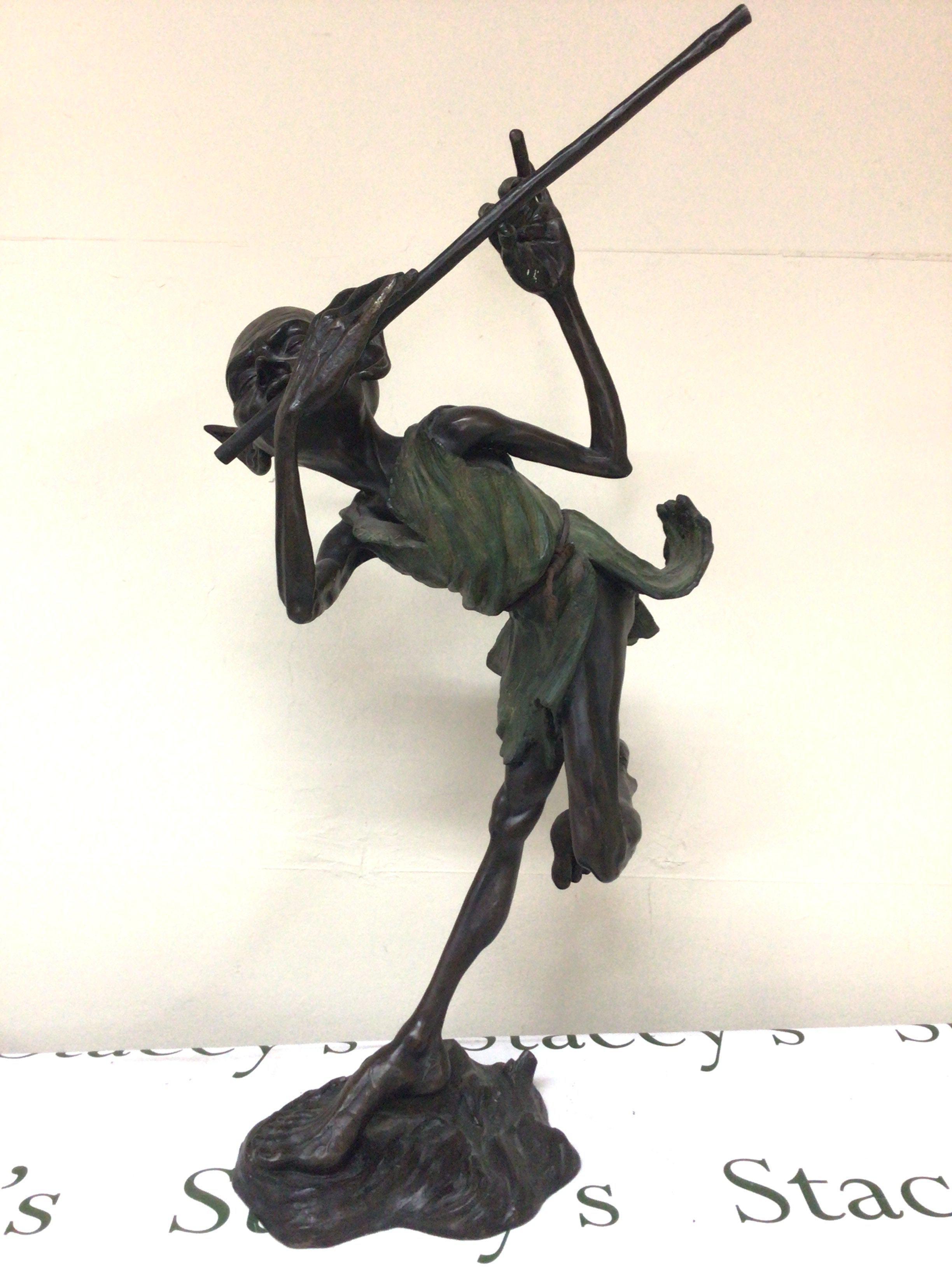 A quality 20th century bronze of a Hoblin playing a flute on a naturalist base the bronze by Julian Jeffrey (b1973) signed base. Hight 73cm