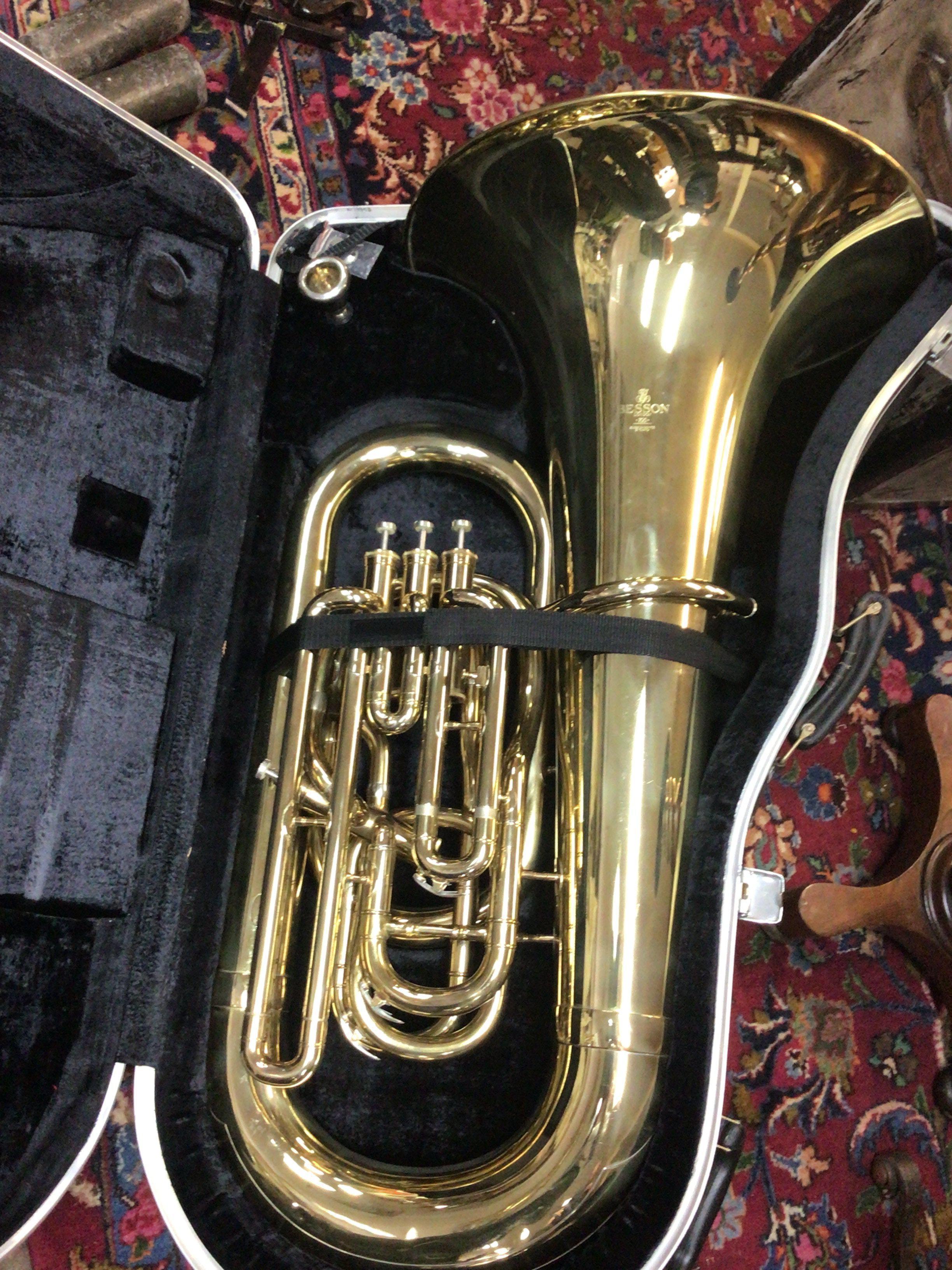 A quality lacquered brass Tuba in a fitted case maker Besson London 700. Condition few scratches and one small dent.