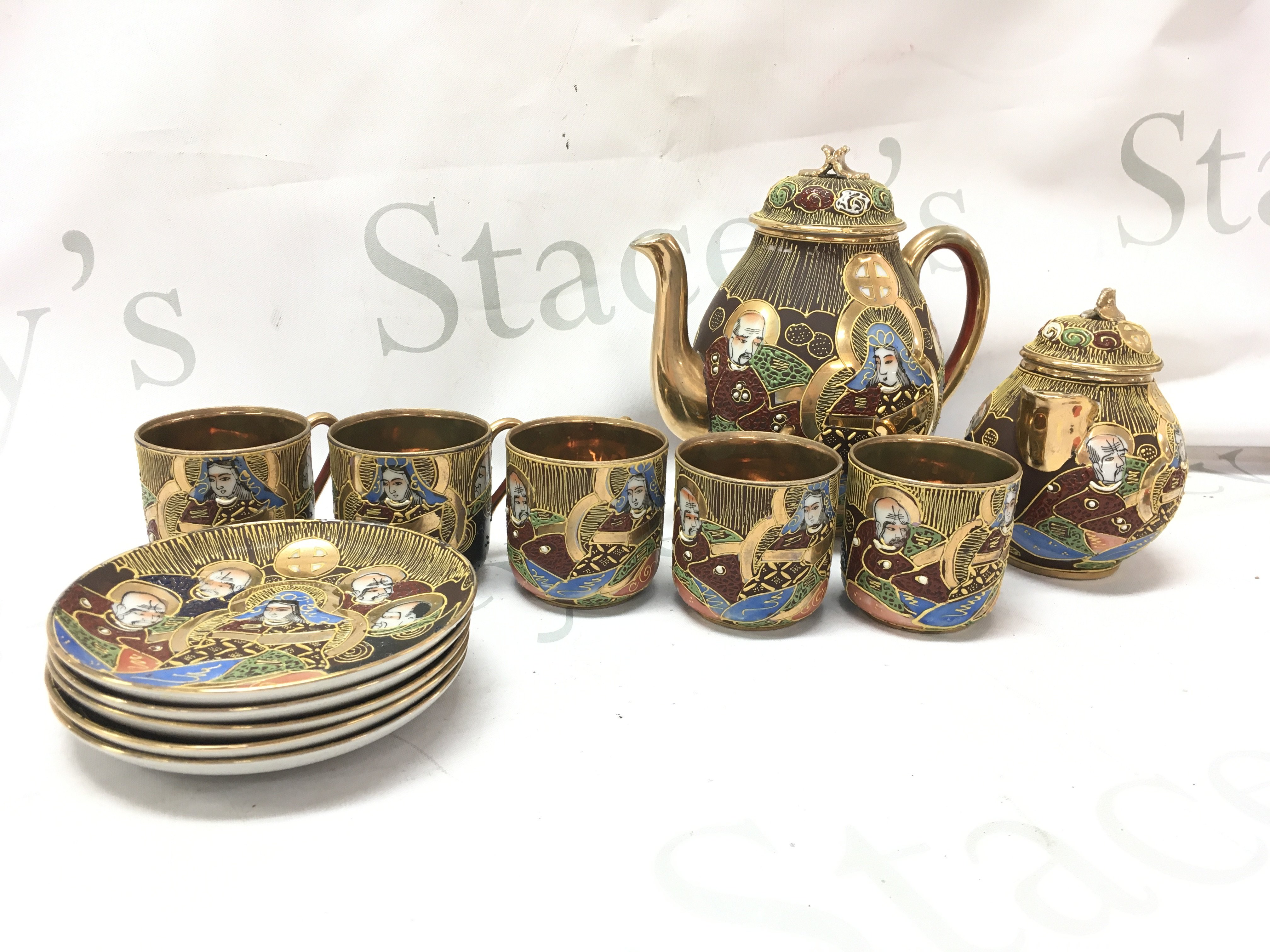 A Japanese part tea set including cups, saucers, milk jug Etc. This lot cannot be posted