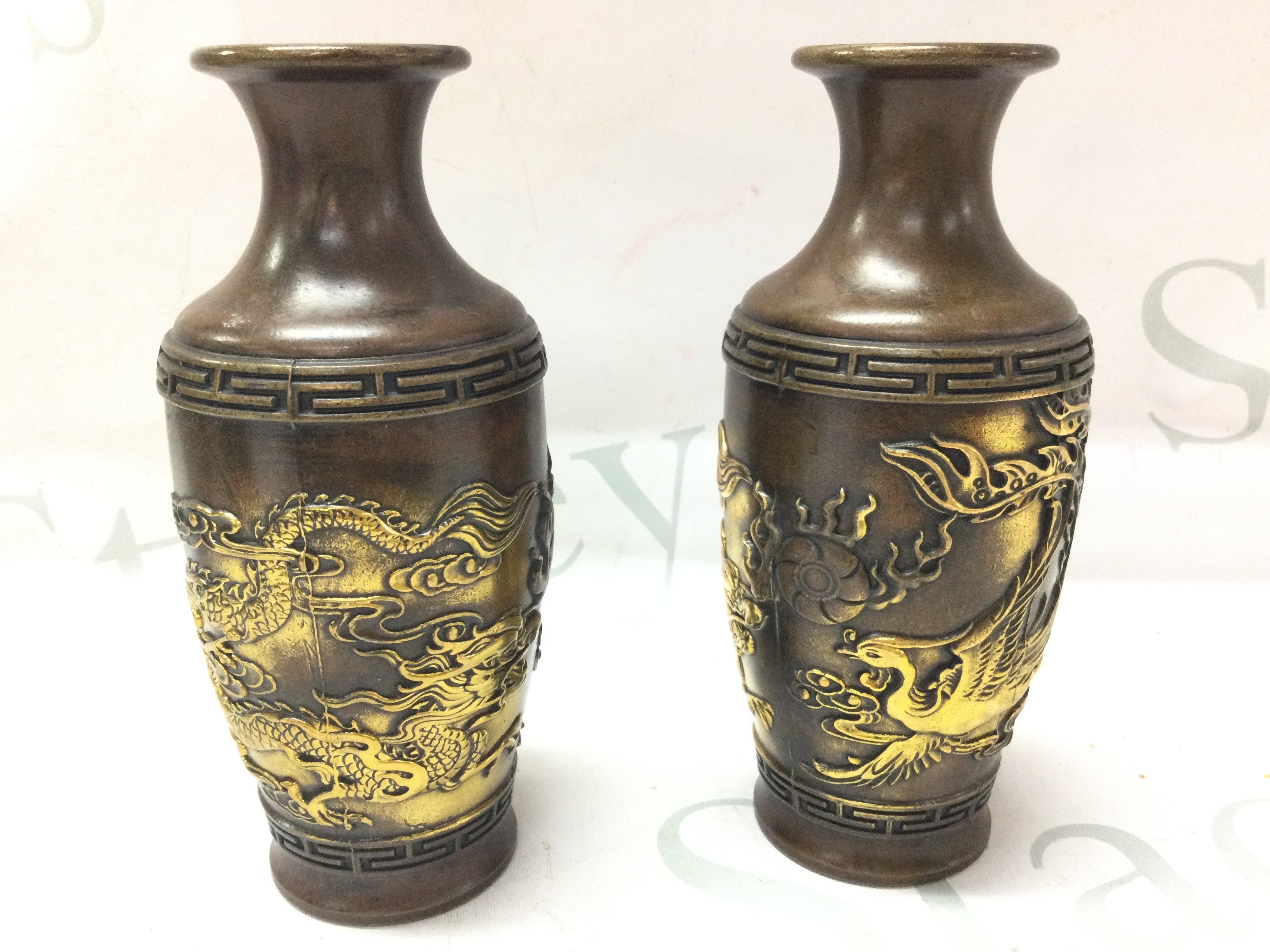 Two Chinese bronze Dragon and Phoenix vases with four character marks at base, 15cm tall. Postage category B