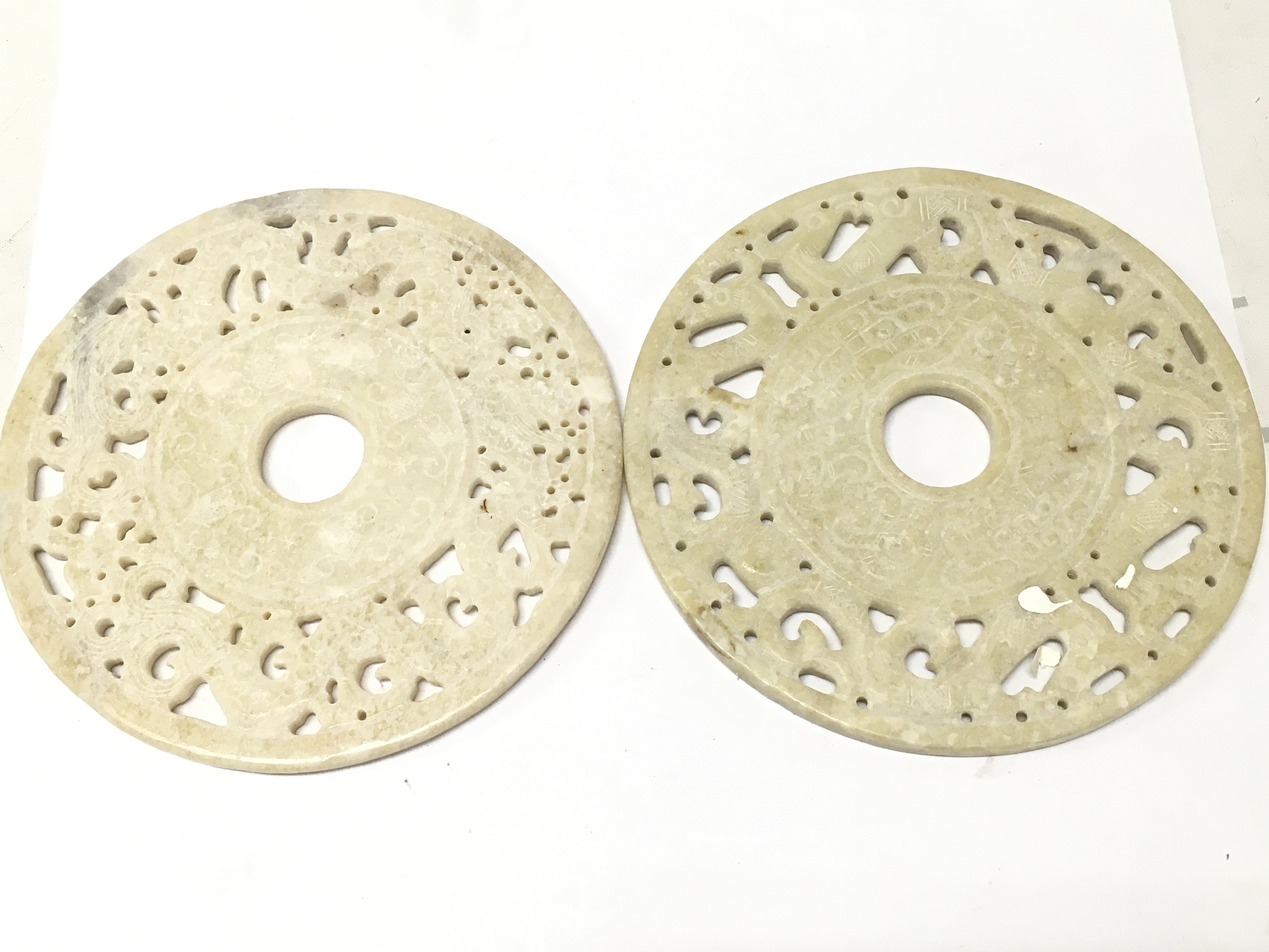 Two Chinese carved and pierced jade bi discs