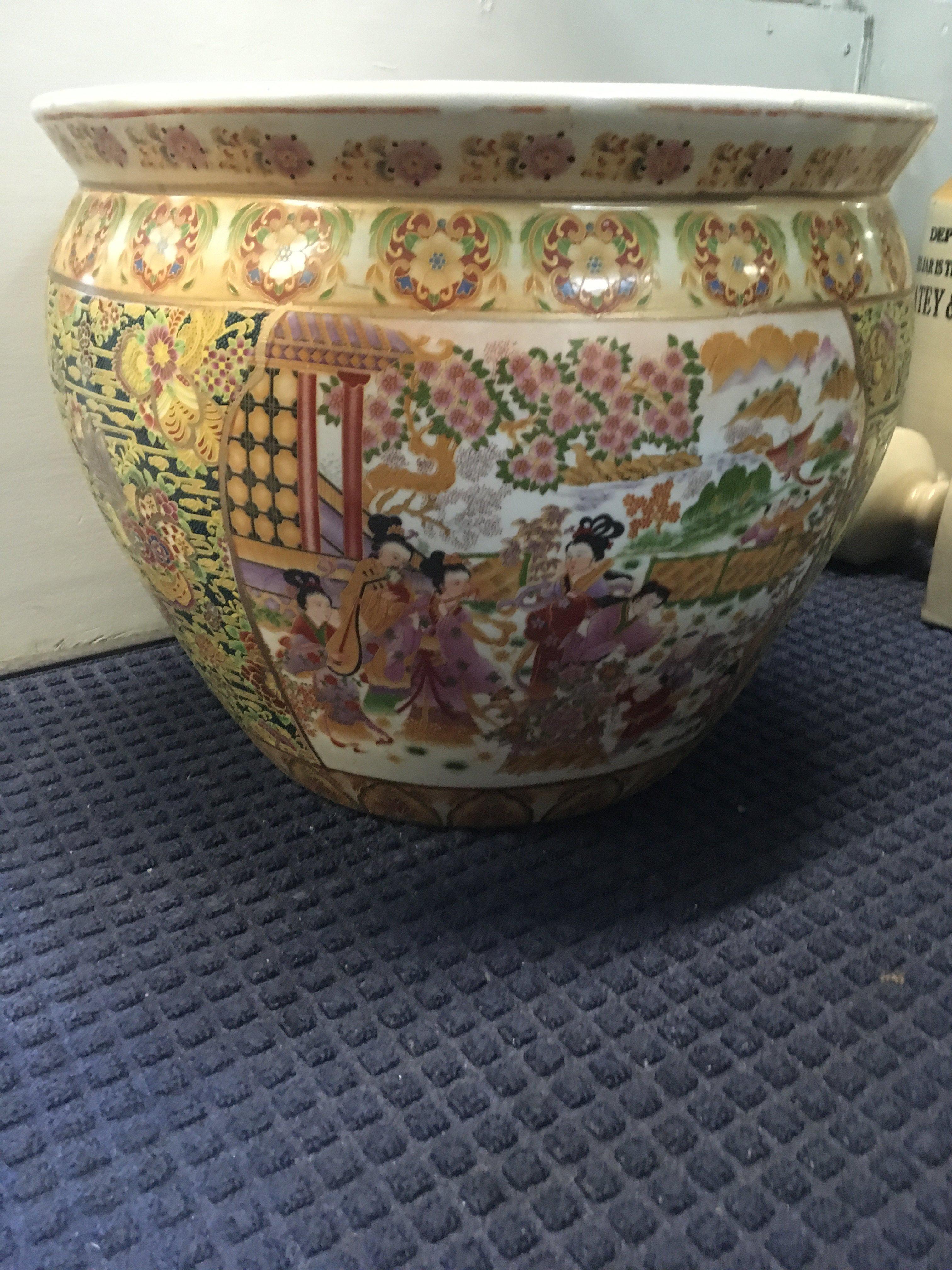 A large Japanese style fish bowl decorated with figures