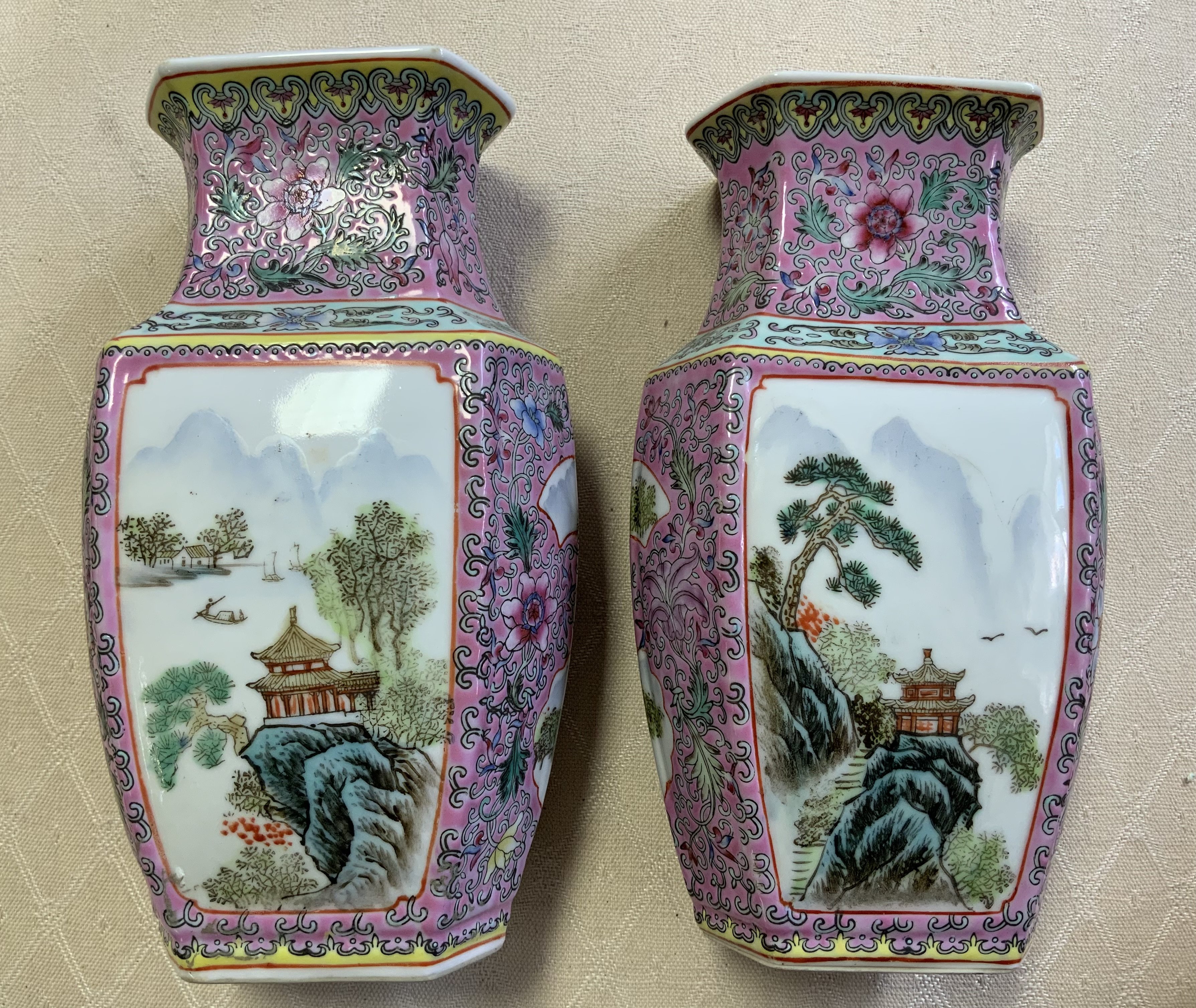 A pair of 20th Century Cantonese porcelain vases with landscape scenes. 20cm.