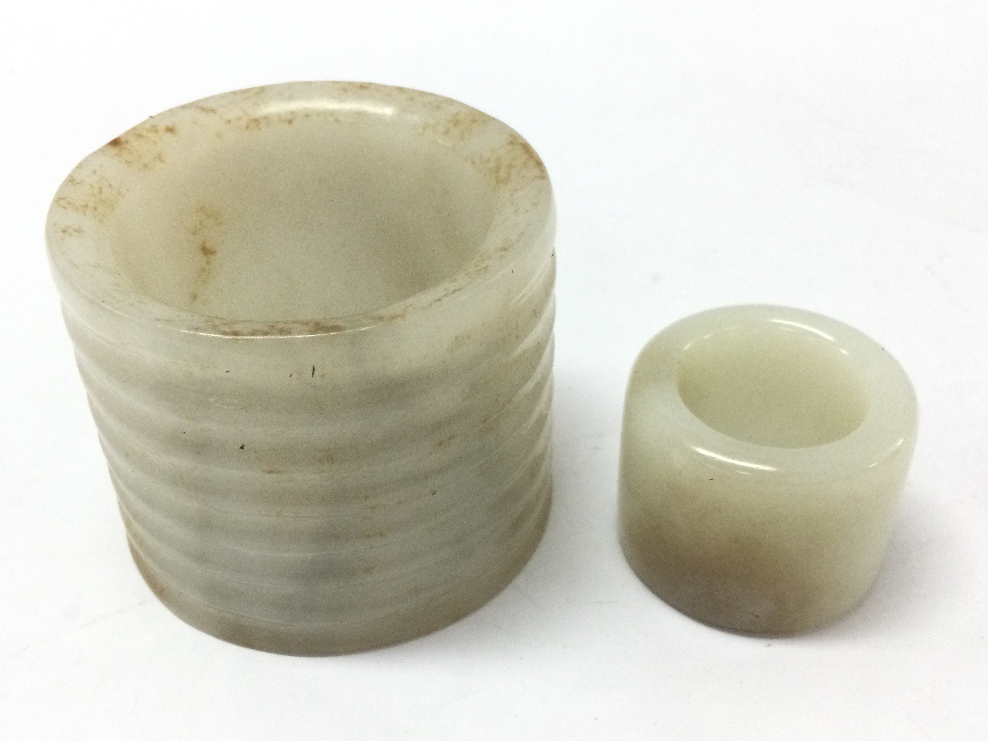 Two jade rings 6 and 3cm wide. 3 & 5Cm tall. Postage category B