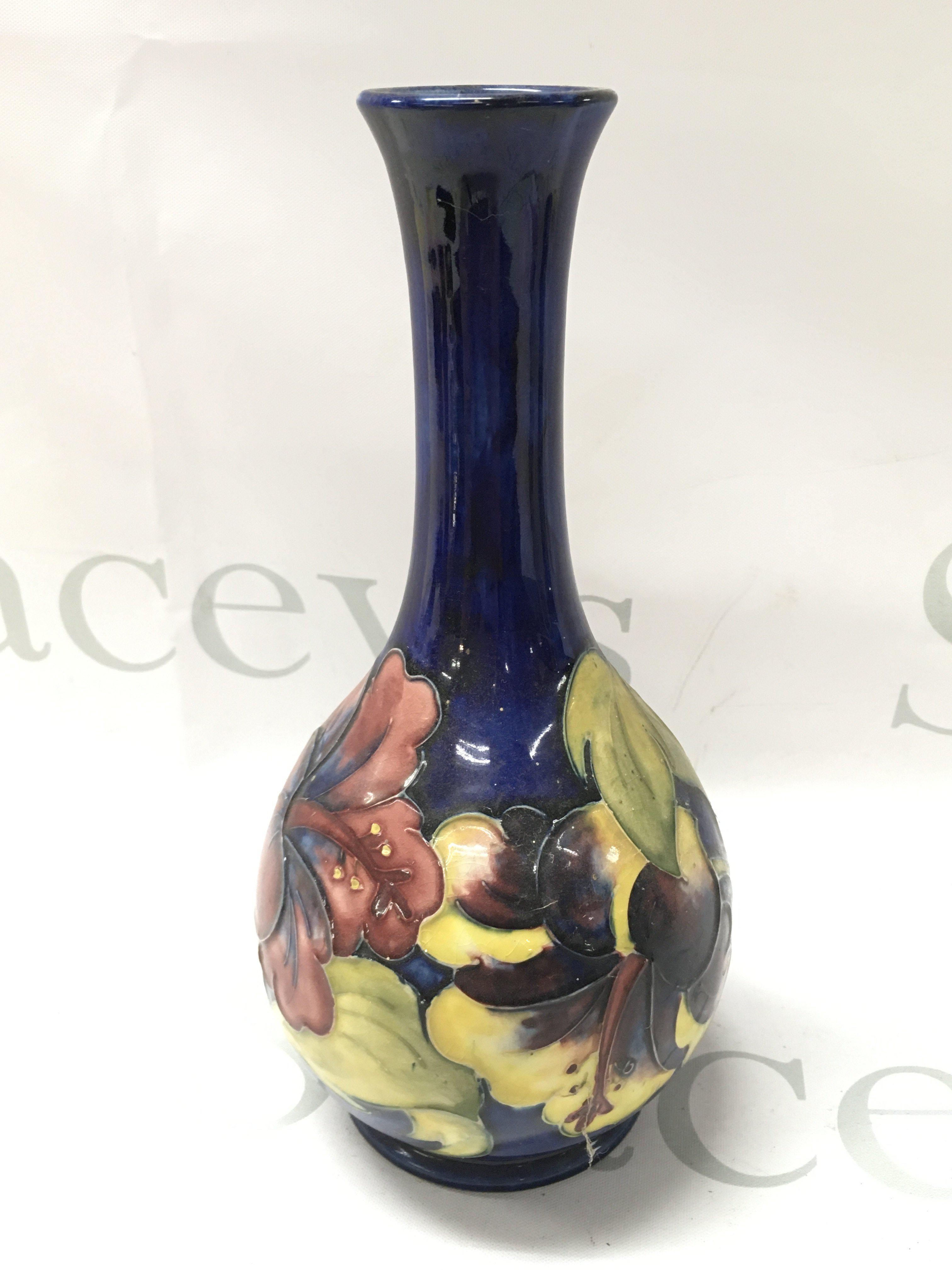 A Moorcroft Hibiscus vase, 21.5cm tall. No obvious damage or restoration, some crazing. This lot cannot be posted
